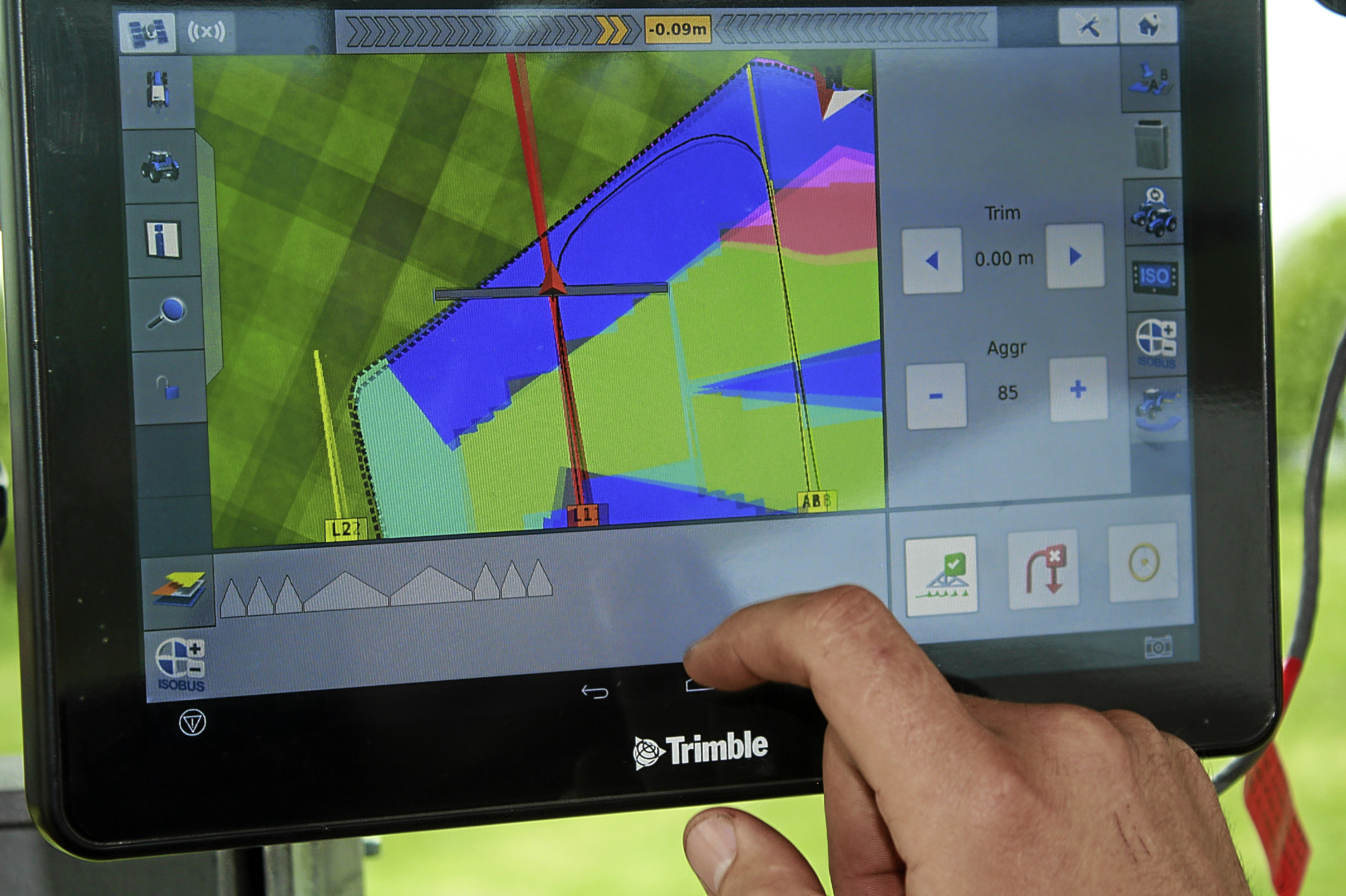 The in-cab monitor in a tractor fitted with autosteer, and variable rate fertiliser spreading technology.