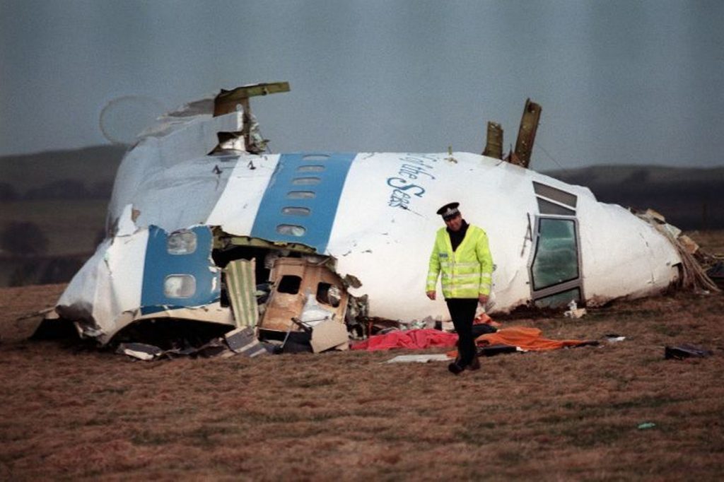 A-policeman-walking-away-from-the-damaged-cockpit-of-the-747-Pan-Am-airliner-that-exploded-and-crashed-over-Lockerbie.jpg
