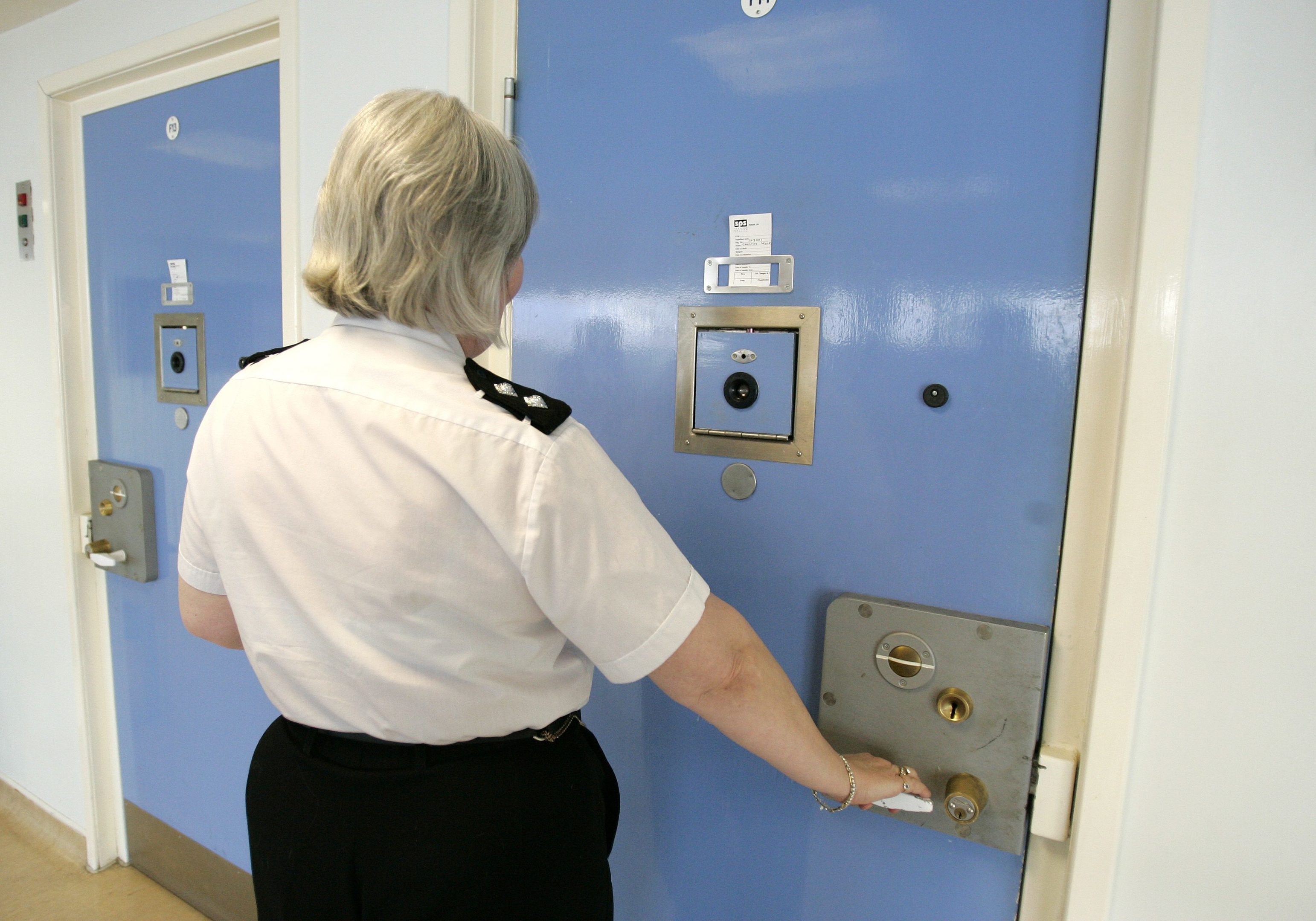A prison officer checking a prison cell at Cornton Vale