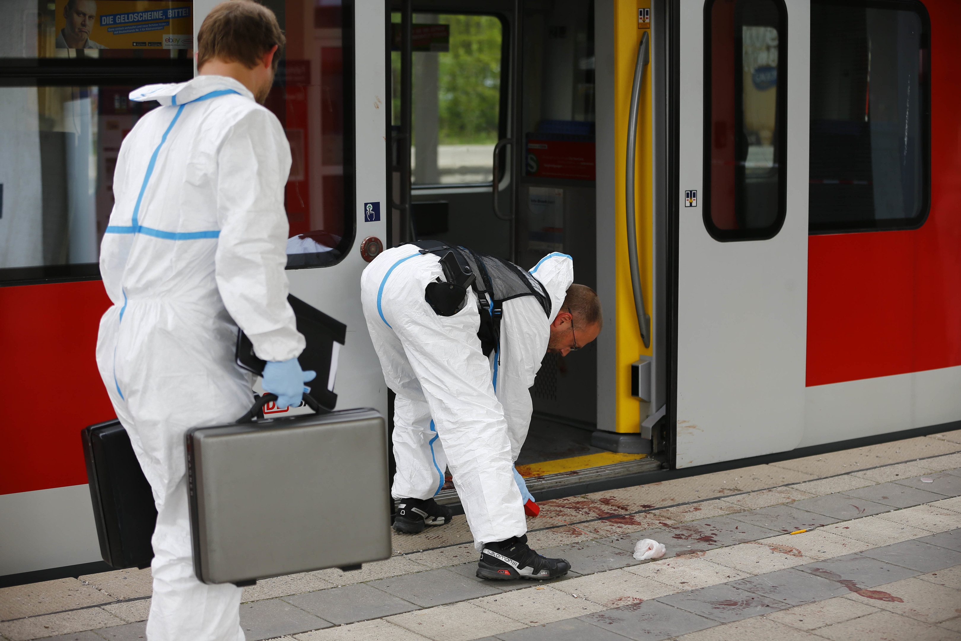 Police investigate the scene of a stabbing at a station in Grafing near Munich in Germany.