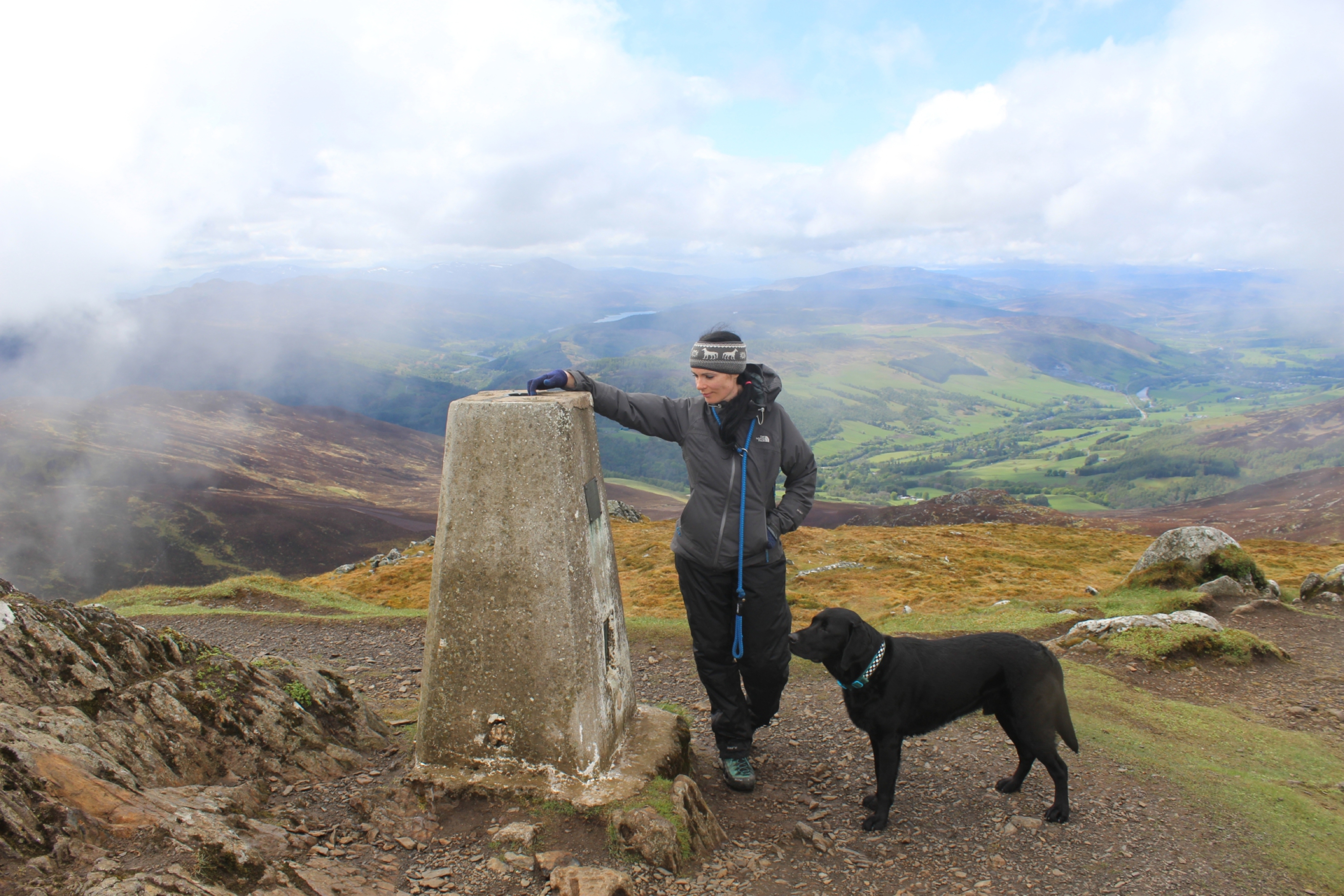 Gayle and her dog Toby at the trig pillar on Ben Vrackie.