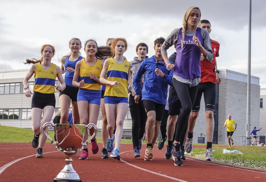 Eilish with Giffnock North AAC athletes at training at Williamwood High School, Glasgow, and the Lindsays Trophy.