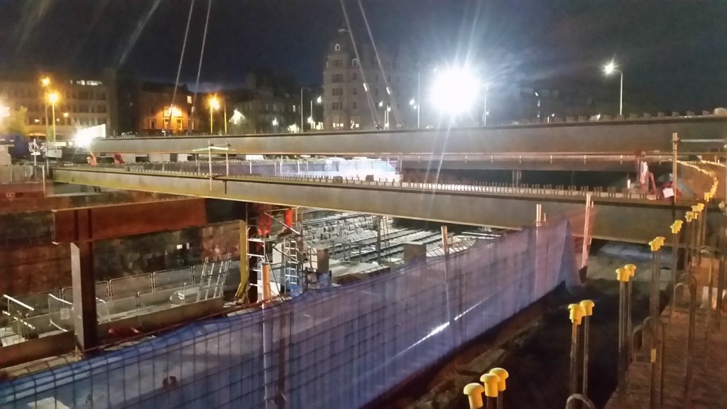 The 18 tonne beams are being craned into place at night, above the east coast main line.