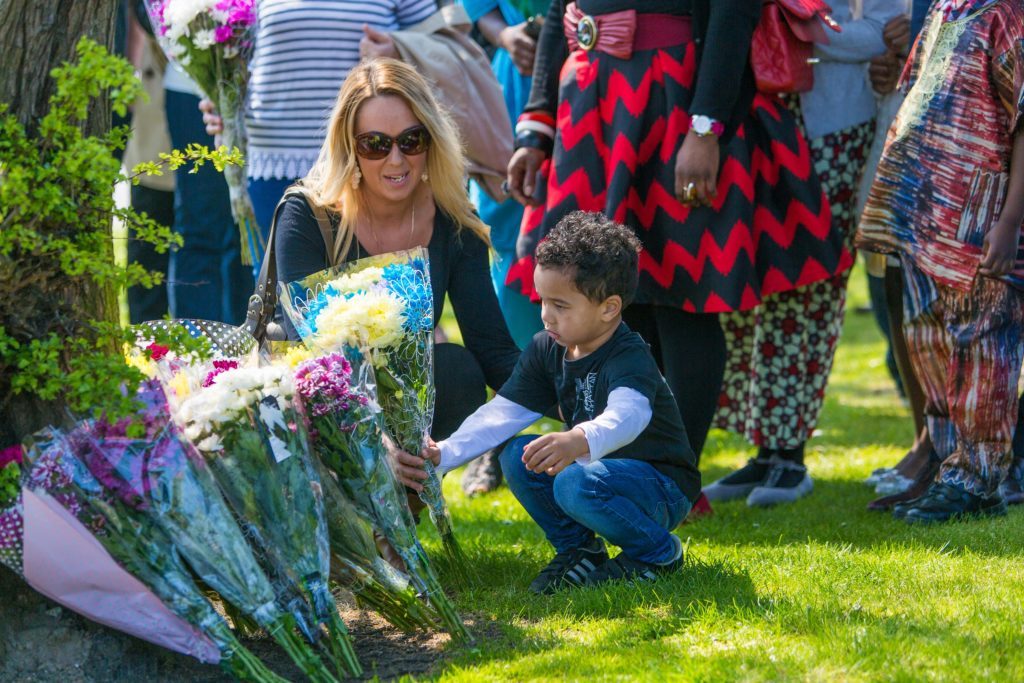 Friends and Family members pay tribute on the anniversary of the death of Sheku Bayoh who died in Police Custody. Together with family lawyer Aamar Anwar, the family laid flowers at the site of his death before meeting in Templehall Community Centre in Kirkcaldy. Sheku's son lays flowers with help from a family member