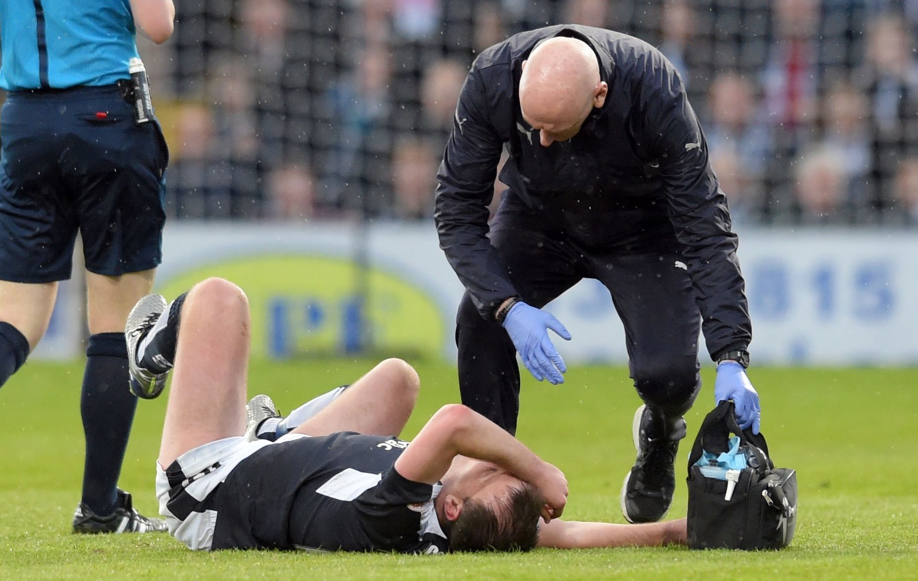 Paul McGowan is injured during the derby.