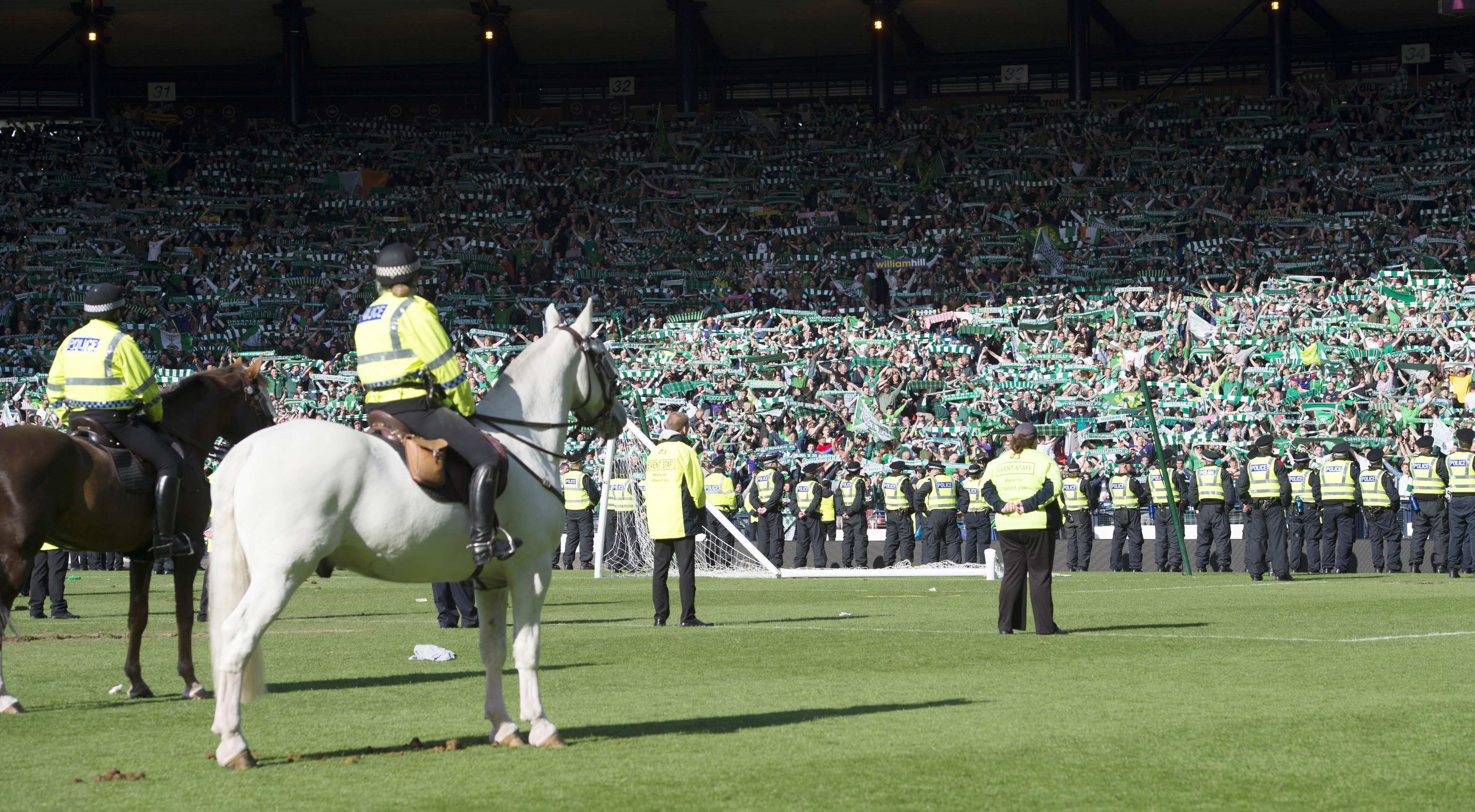 Hibs fans rushed on to the pitch after the full time whistle.