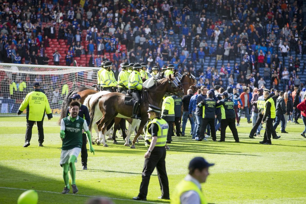 File photo dated 21/05/16 of police horses trying to guide fans off the pitch after the William Hill Scottish Cup Final at Hampden Park, Glasgow. Police are continuing to investigate fan violence at the end of the match as Rangers hit out at the handling of the trouble. PRESS ASSOCIATION Photo. Issue date: Monday May 23, 2016. The Glasgow football club said several players and staff were assaulted as thousands of Hibernian supporters flooded on to the pitch following the Edinburgh team's dramatic 3-2 win at Hampden Park. See PA story SPORT ScottishCup. Photo credit should read: Jeff Holmes/PA Wire EDITORIAL USE ONLY