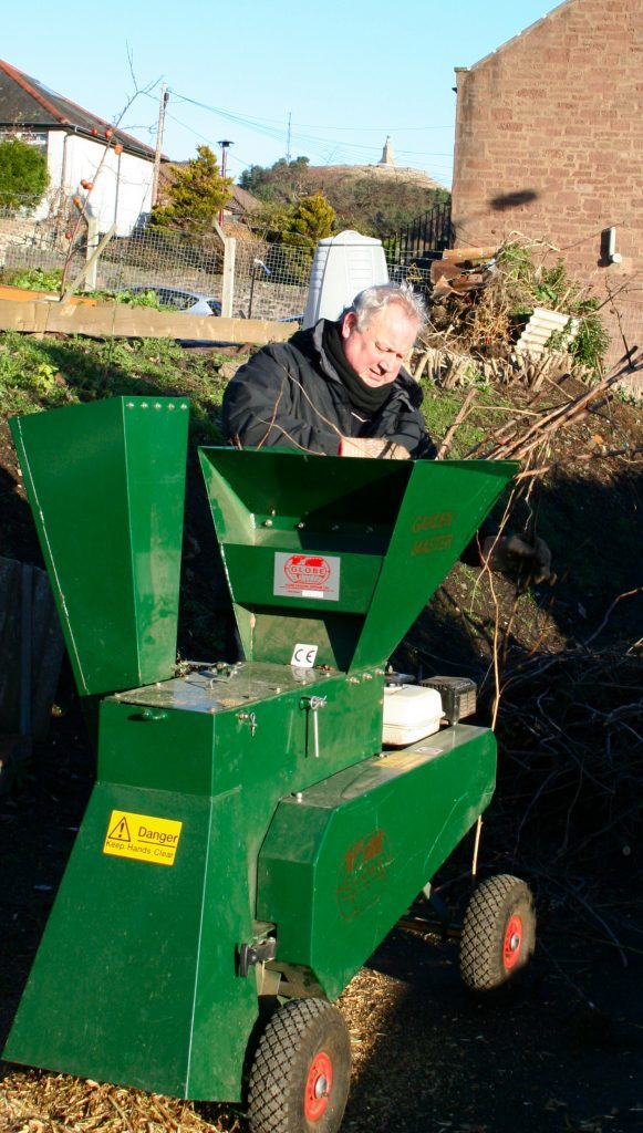 Shredding prunings at City Road allotments