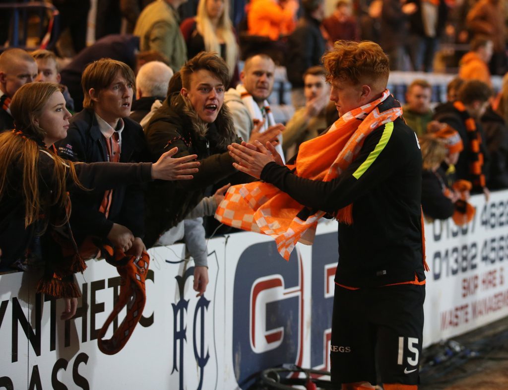 Dundee United's Simon Murray is consoled by fans after being relegated at the end of Mondays game against Dundee