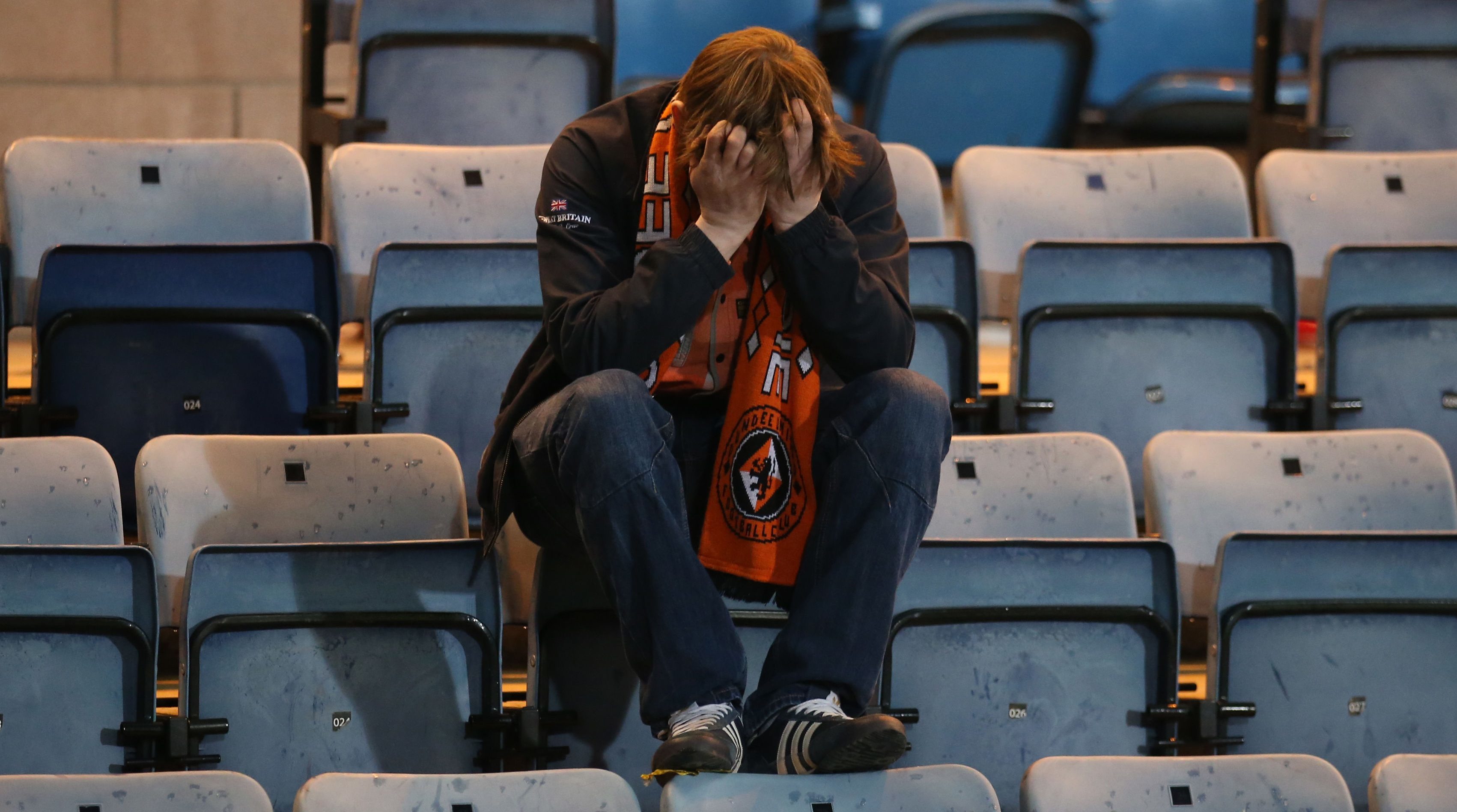 A Dundee United fan appears dejected after his side is relegated at the end of the Ladbrokes Scottish Premiership match at Dens Park.