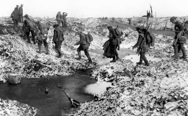 British soldiers negotiating a shell-cratered, winter landscape along the River Somme in late 1916 after the close of the Allied offensive.