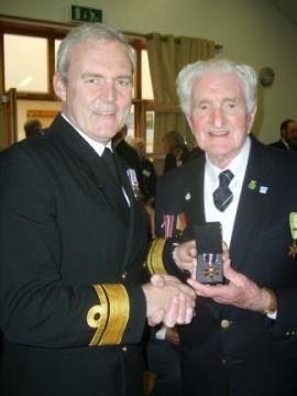 Mr Haddow senior receives his Arctic Star medal from Lieutenant Colonel Douglas Young in 2013.