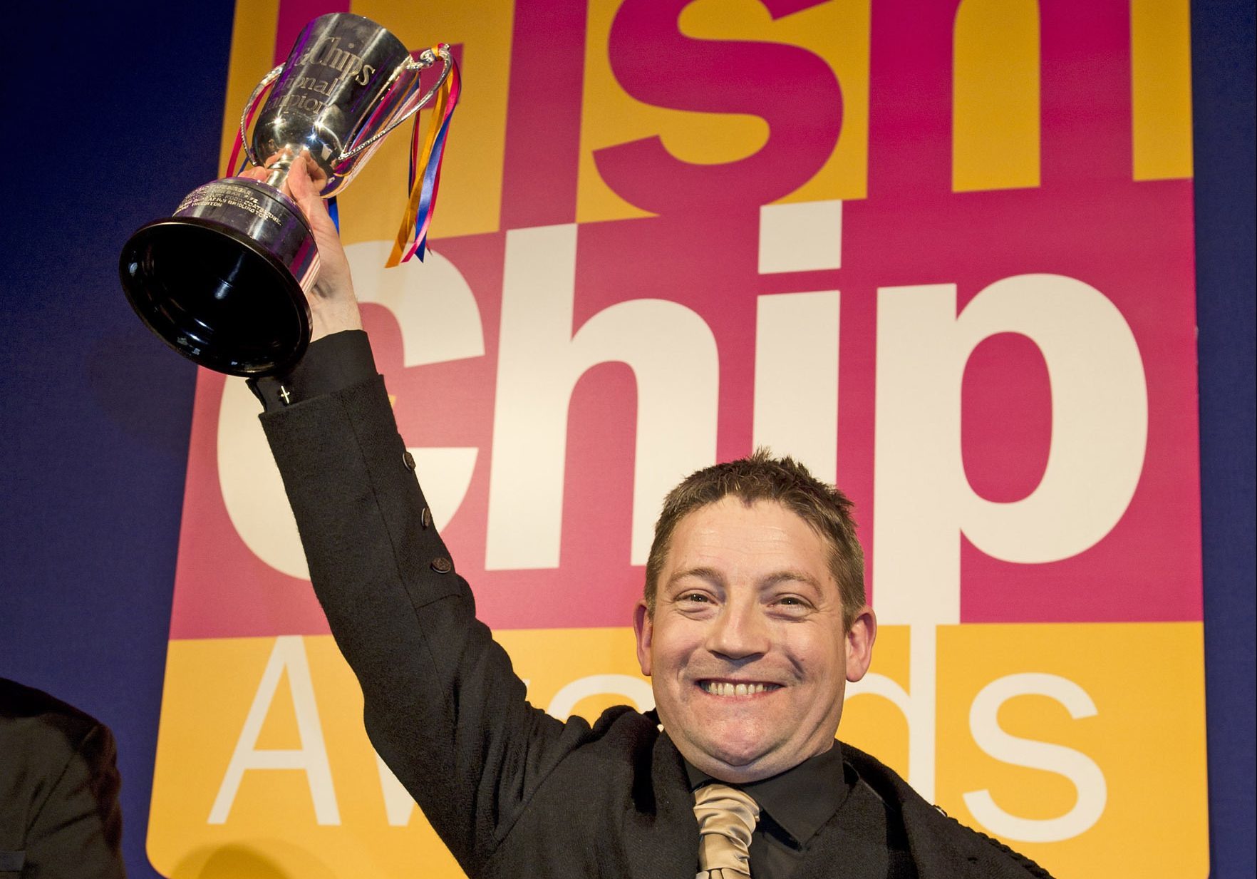 Calum Richardson picking up an trophy at the Independent Takeaway Fish and Chip Shop of the Year awards.