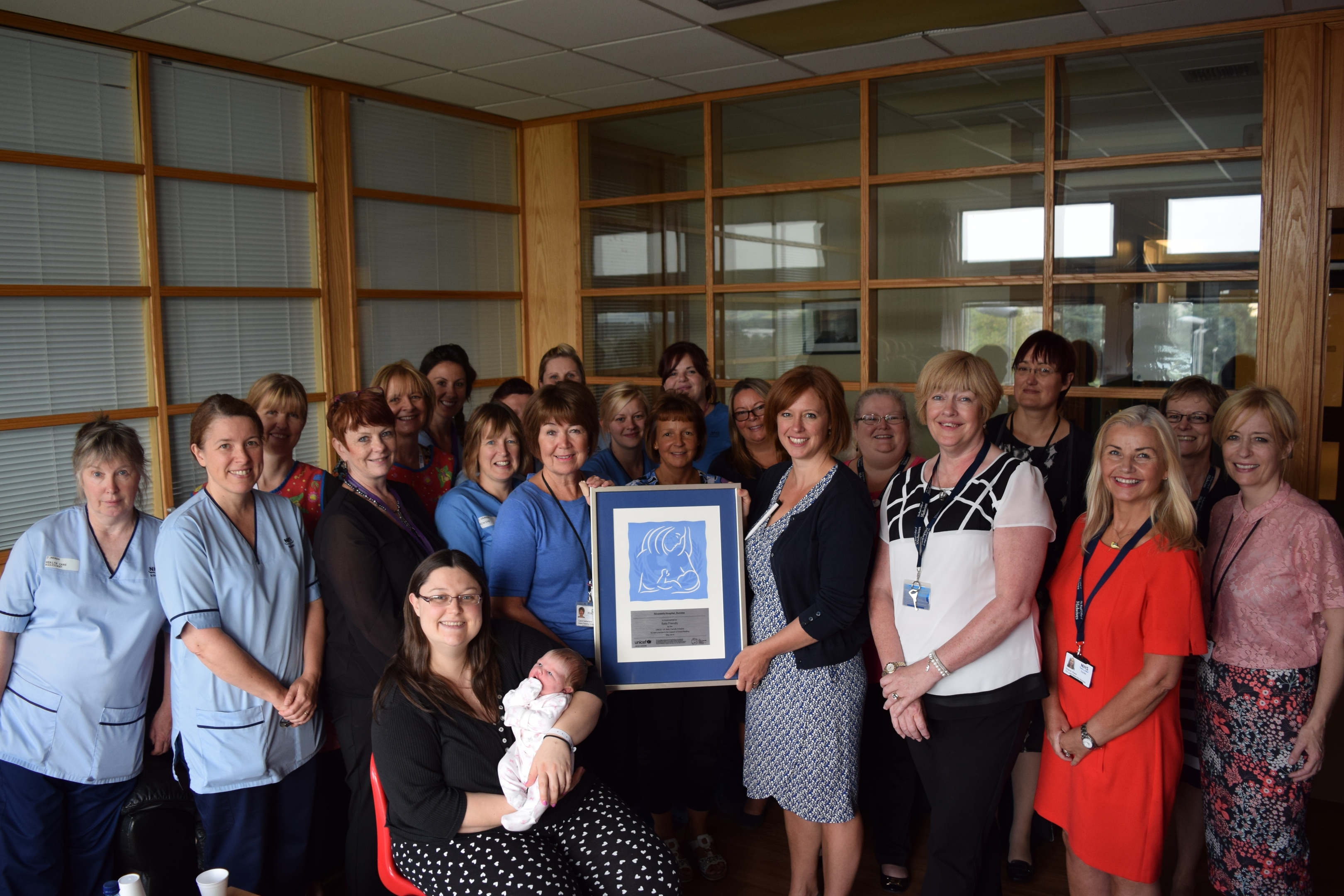 Ninewells maternity department received a Unicef baby friendly award in 2014. Justine Craig, head of midwifery, is holding the award on the right hand side.