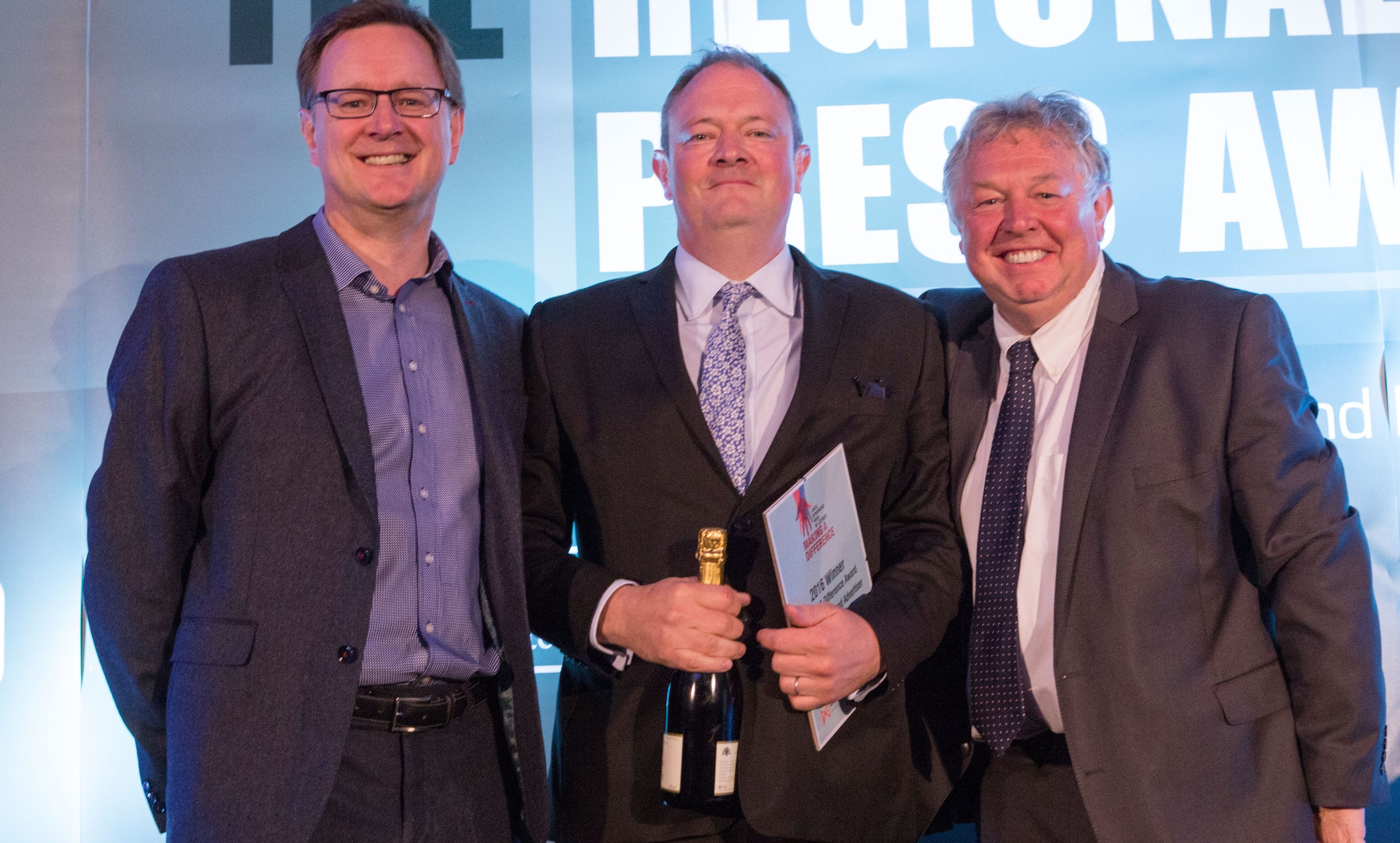 Courier editor Richard Neville accepting the making A Difference Award from Ashley Highfield, left, and host Nick Ferrari, right.