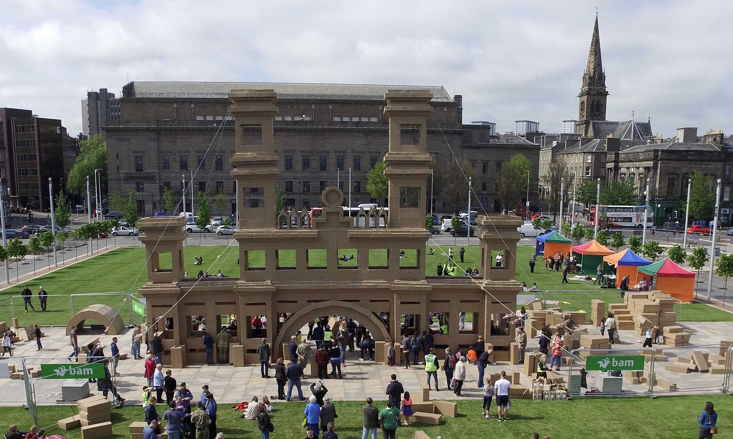 The sun comes out for the volunteers building the cardboard Royal Arch.