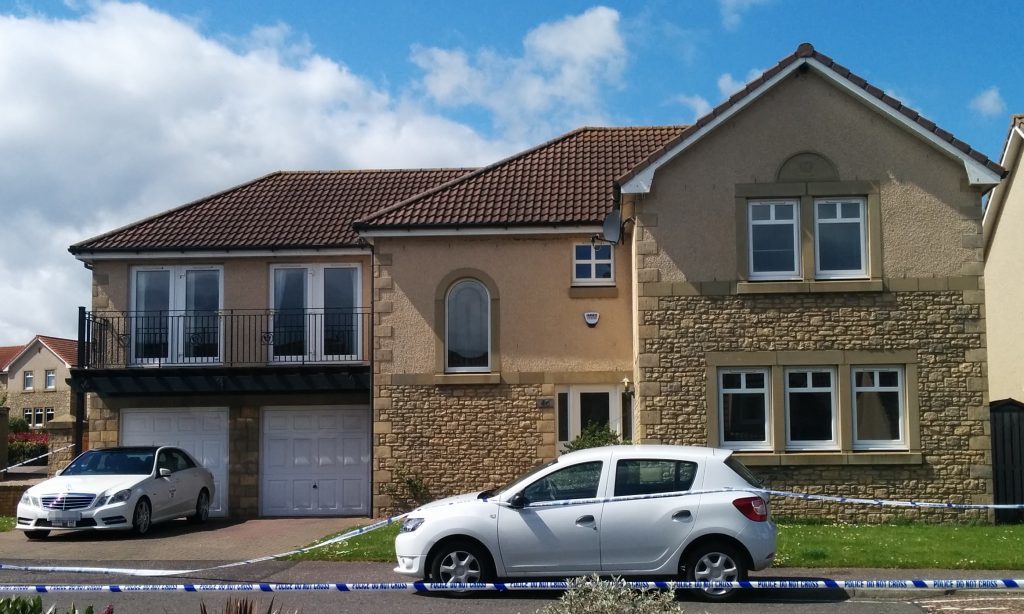 The house sealed off by police.