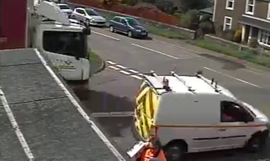 The van blasts past the lorry and over crossroads.
