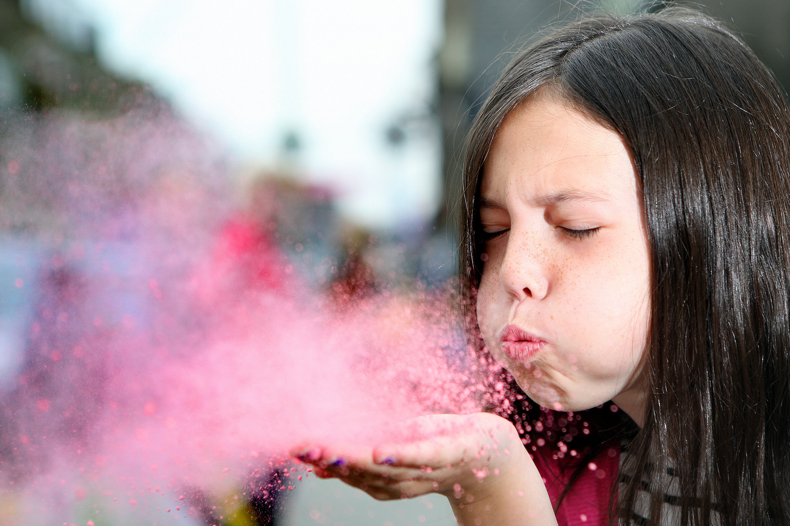 Emily Thomson blows chalk dust off her hand during the pavement art competition.