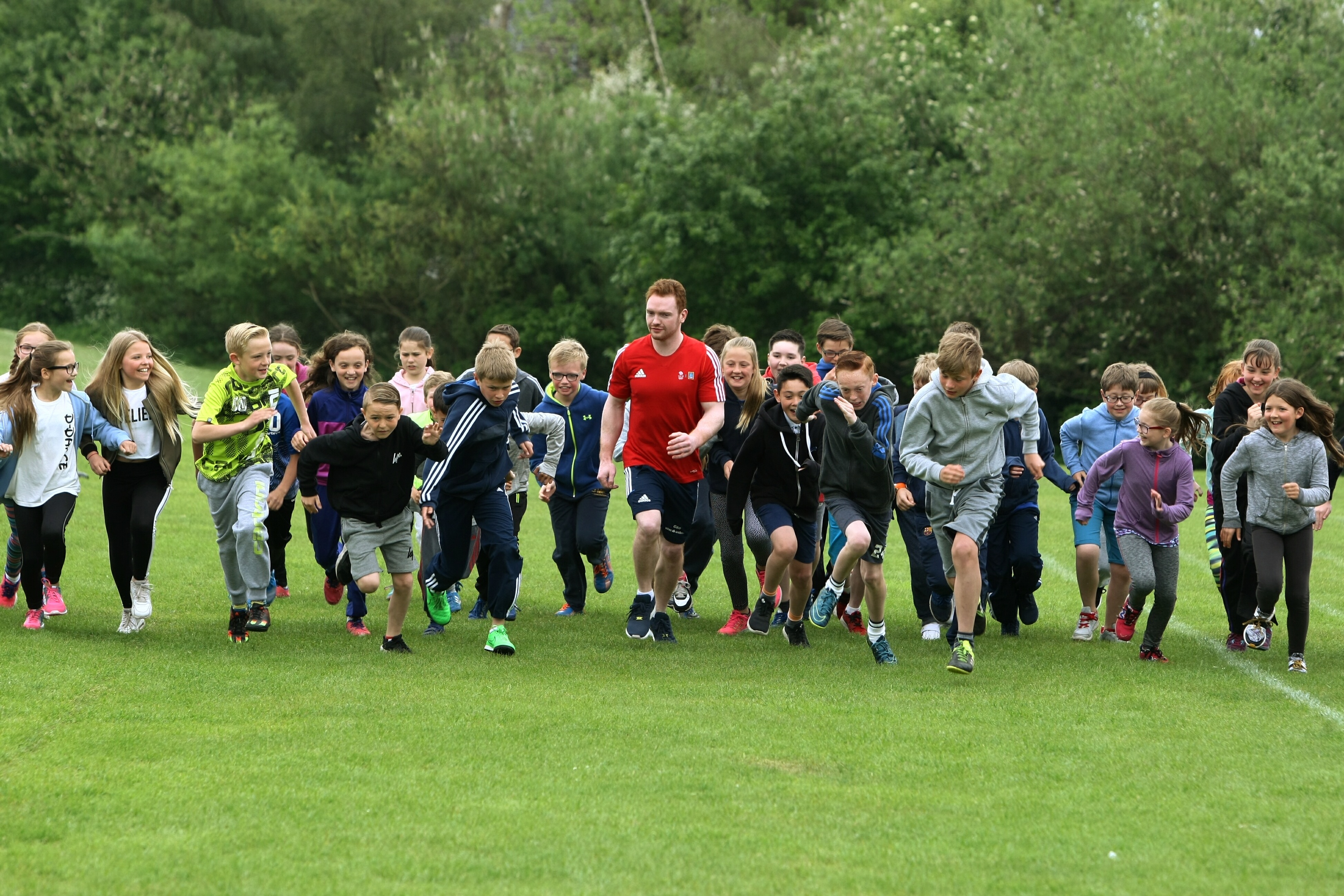 Team GB Gymnast, Dan Purvis (in the red shirt) taking part with the P6s on their daily mile