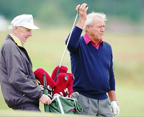 Tip Anderson left) caddies for Arnold Palmer at the Open Championship, St Andrews, in 1995