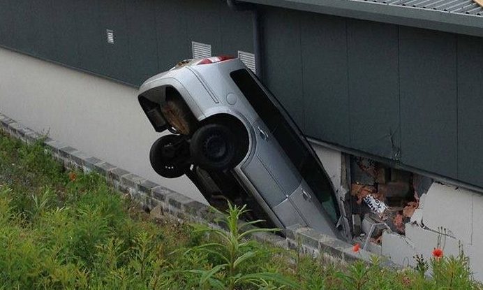 The car caused significant damage to the store wall.