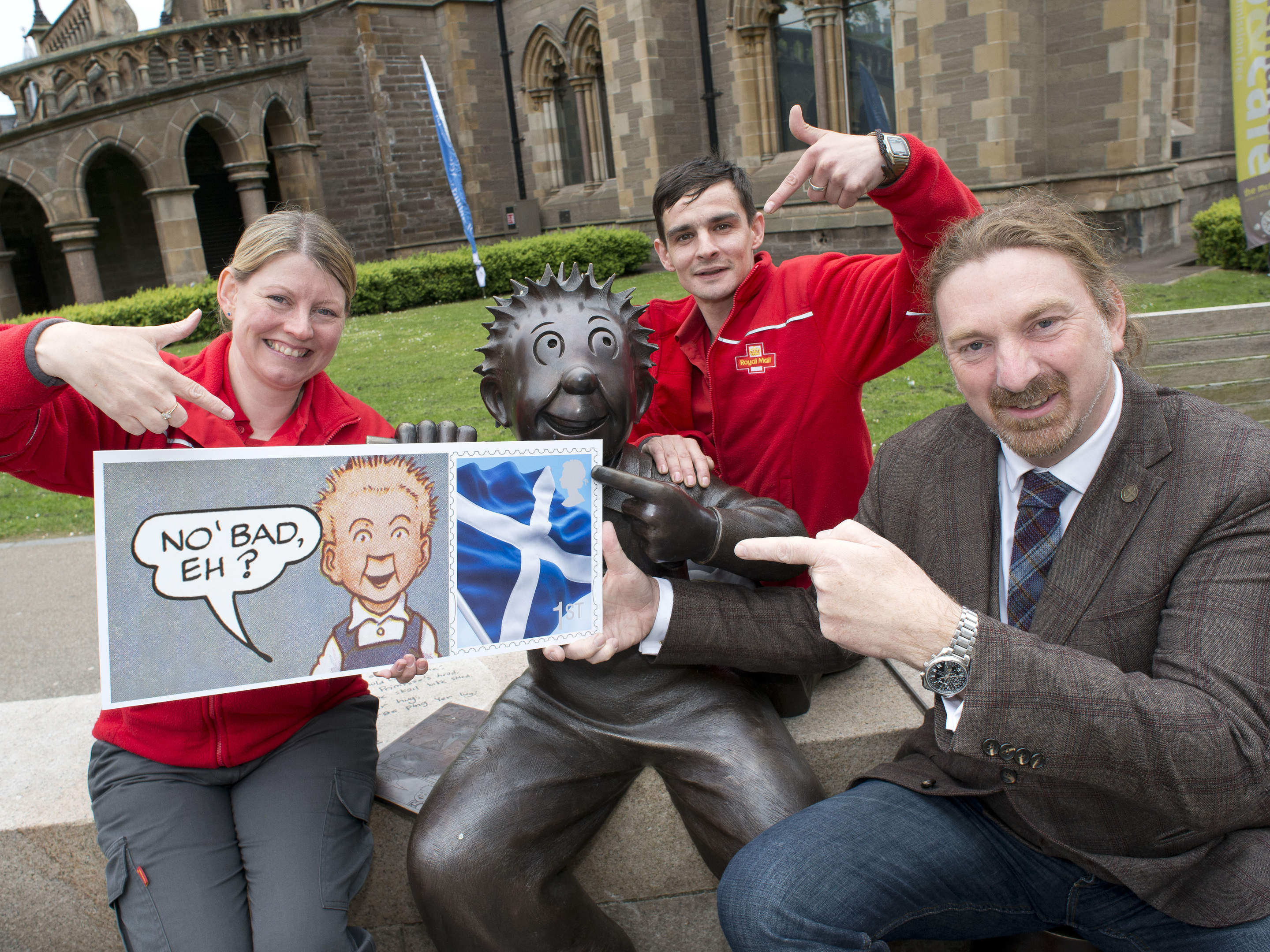 Dundee West MP Chris Law with posties Leigh O'Connor and Martin McGuinness celebrate the arrival of the new stamps which mark the characters' 80 years in print.