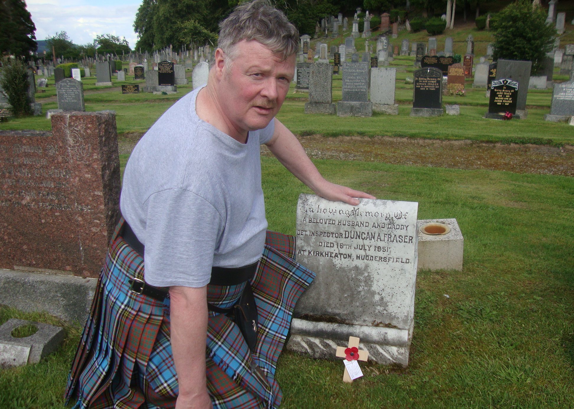 Mr Anderson pictured at the grave of Detective Inspector Duncan Fraser.