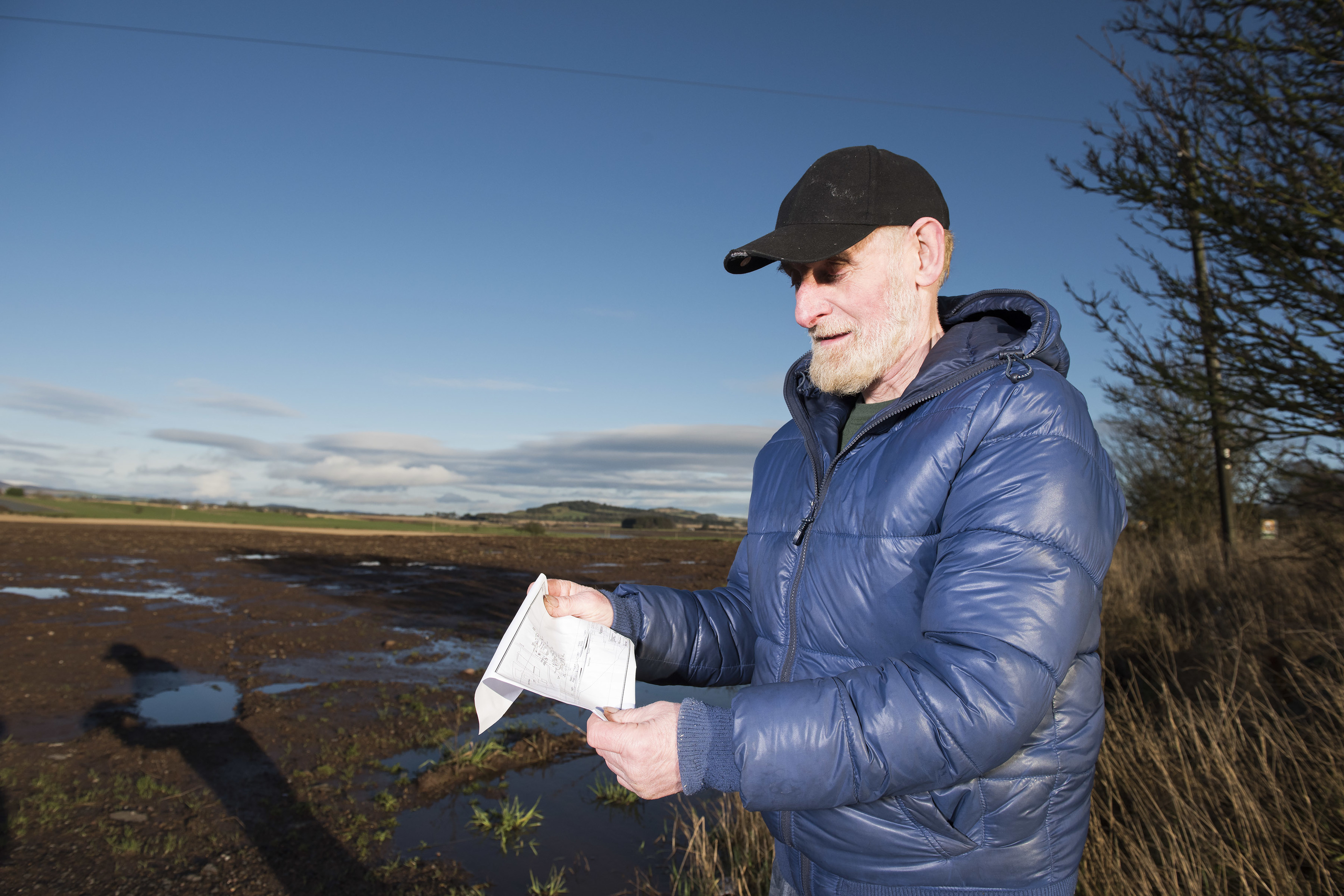 Resident Frank Morrison looks at a copy of the plans for a new recycling centre at Padanaram.