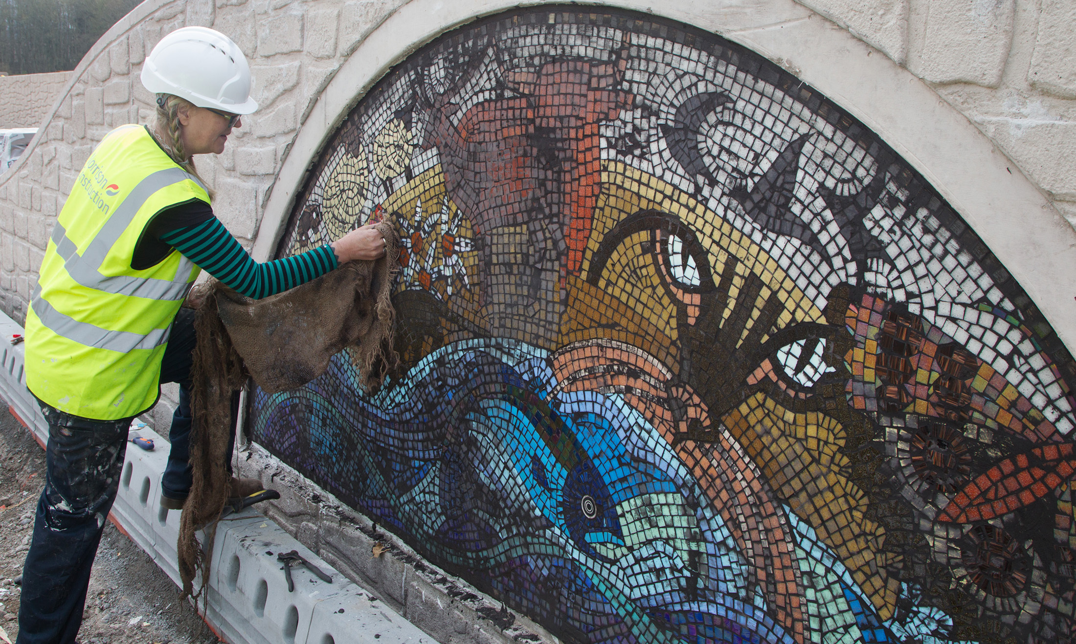 Maureen Crosbie hard at work on the murals earlier this year.