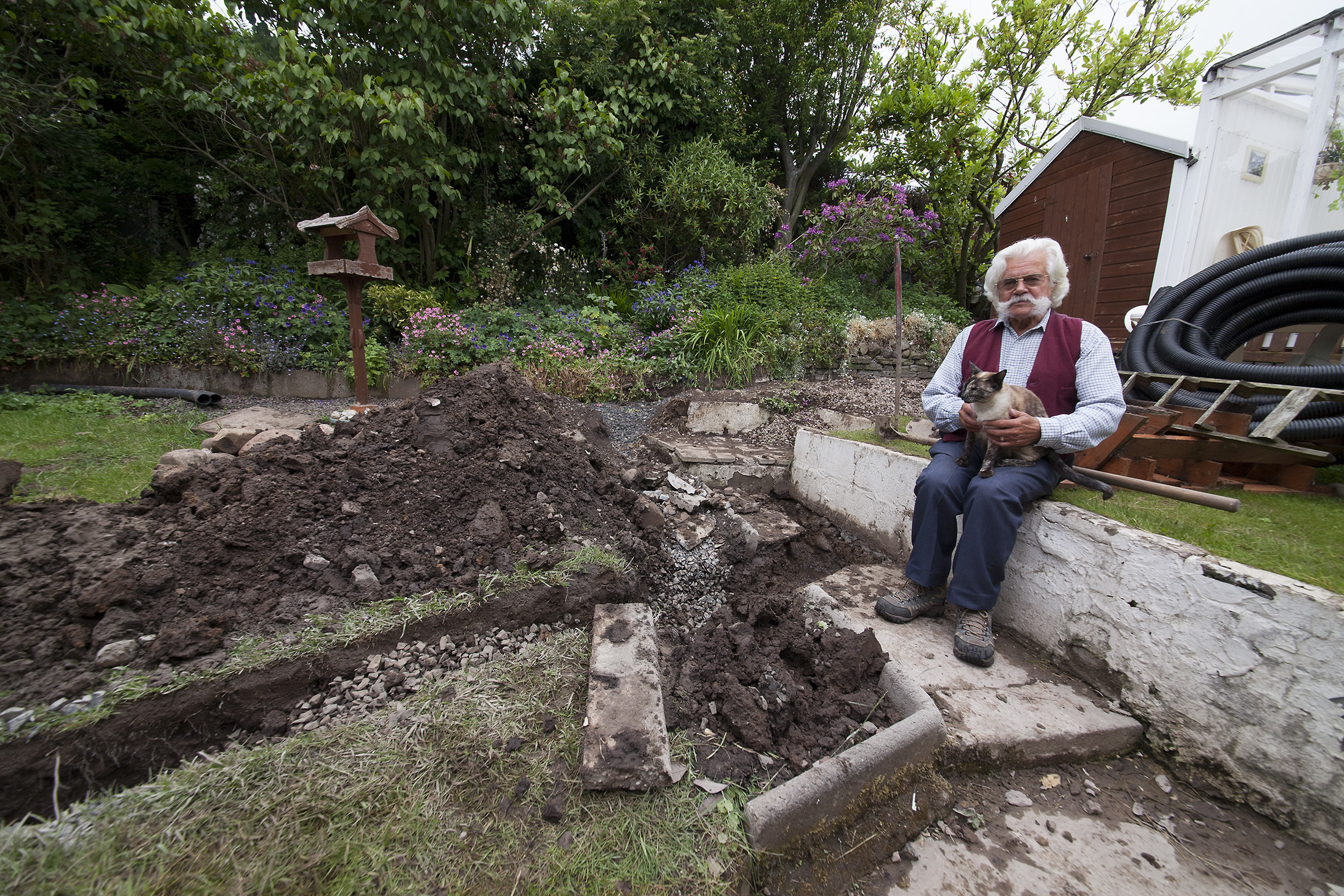 James Doig, with cat Coco, in his garden in June.