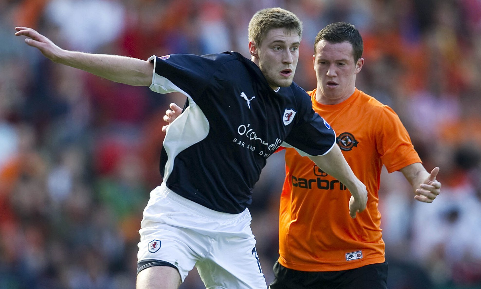 Iain Williamson (left) holds off Danny Swanson in the 2010 Scottish Cup semi-final between Raith Rovers and Dundee United.