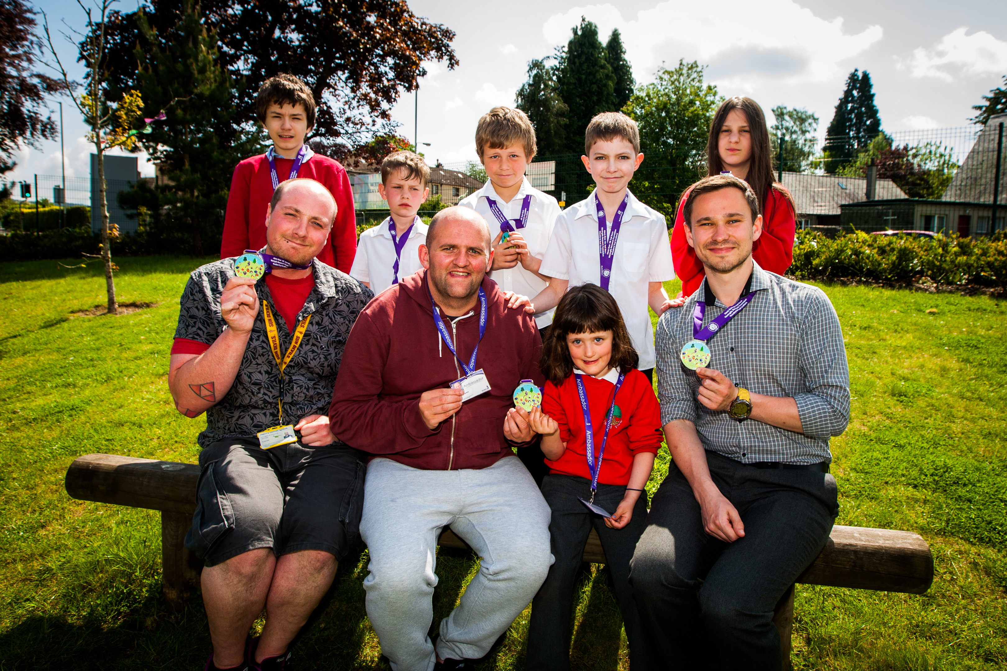 Alan Glynn presenting medals for the Alexis Rose Trail Race to pupils who designed the medal. He and his daughter Christina have already raised more than £100,000 for meningitis charities.