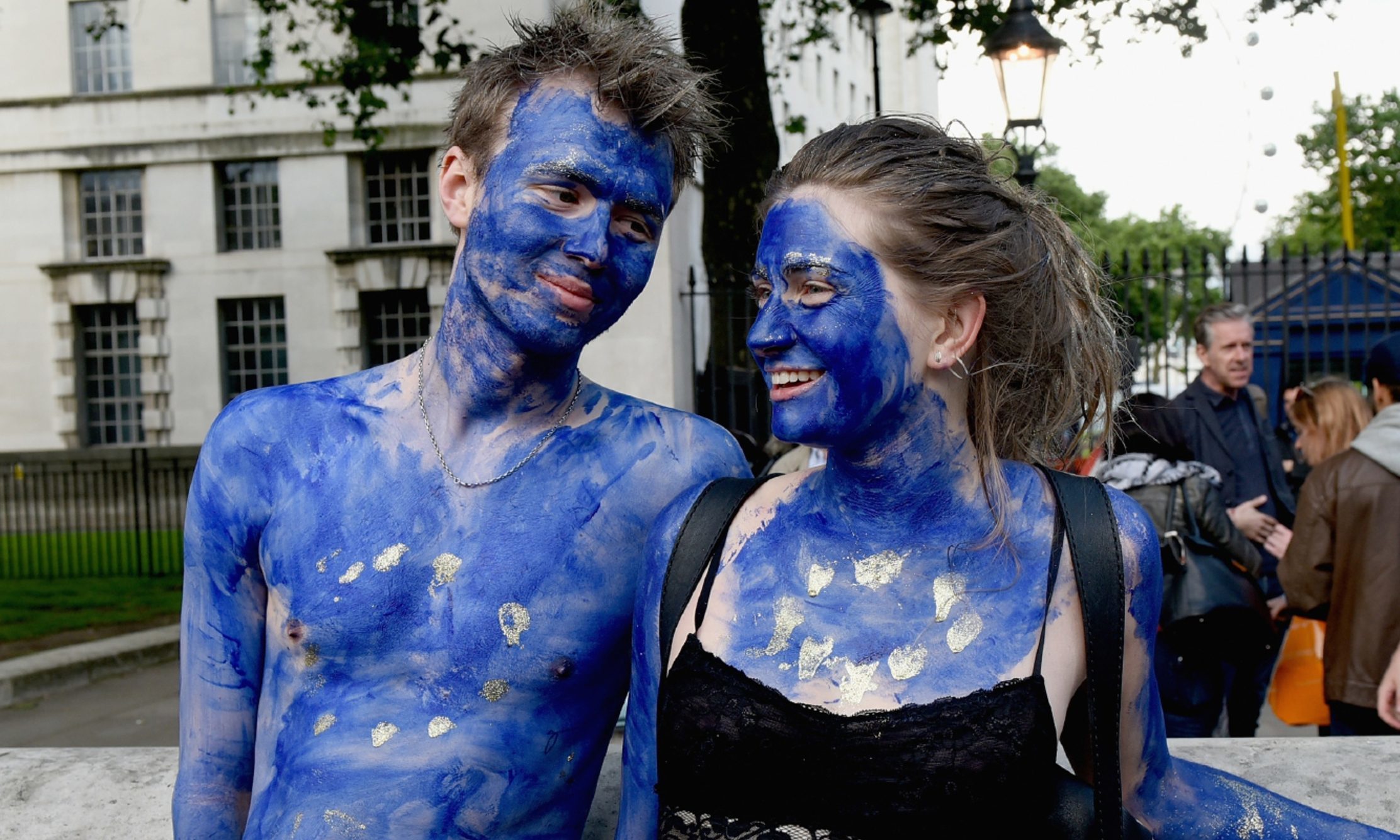 A young couple painted as EU flags protest outside Downing Street against the United Kingdom's decision to leave the EU.