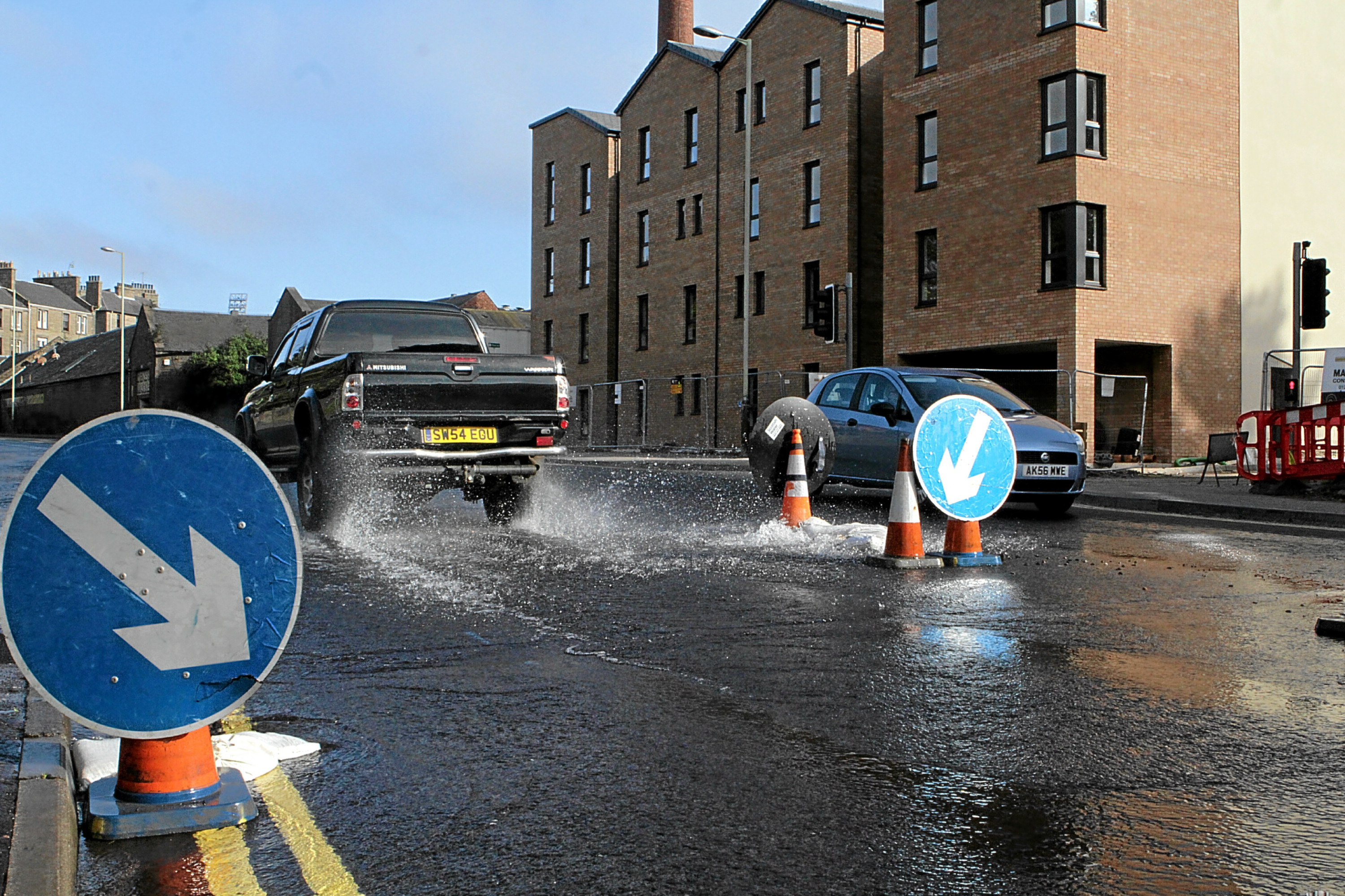 The burst water pipe on Dens Road at the junction with Alexander Street.