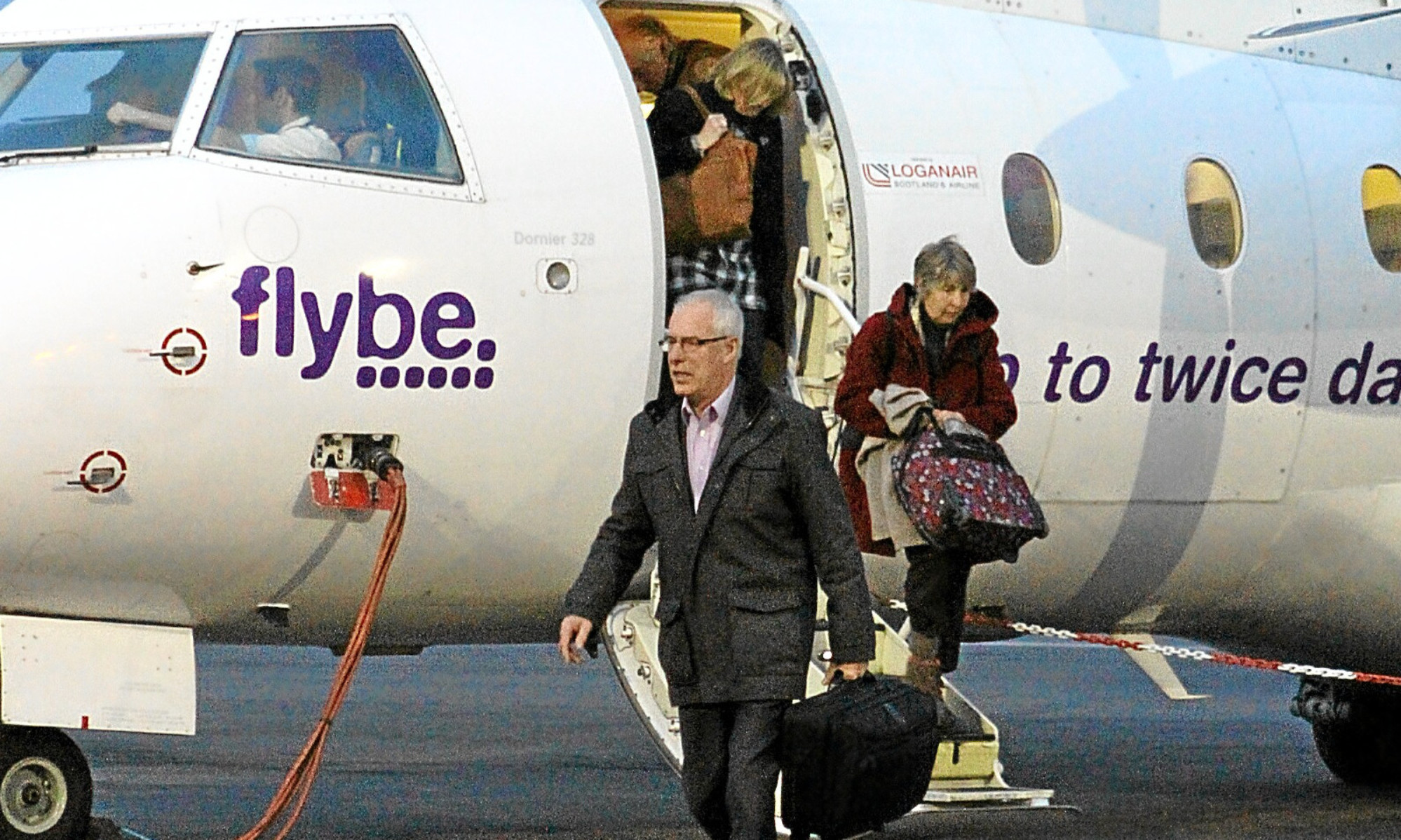 Passengers disembark from a Flybe flight at Dundee Airport