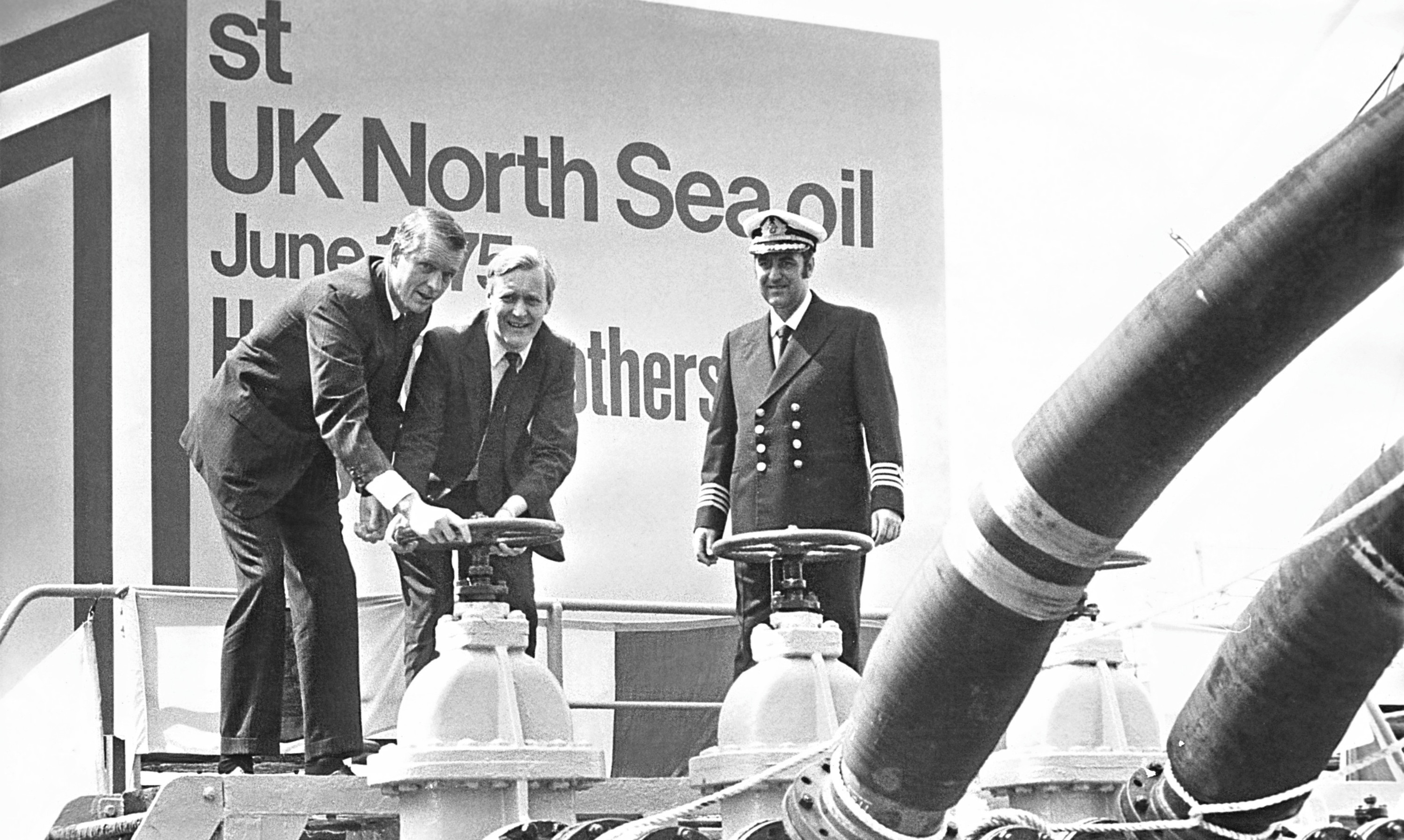 Former Energy Secretary Tony Benn opens a valve to release the firstoil from the Argyll field in the North Sea.