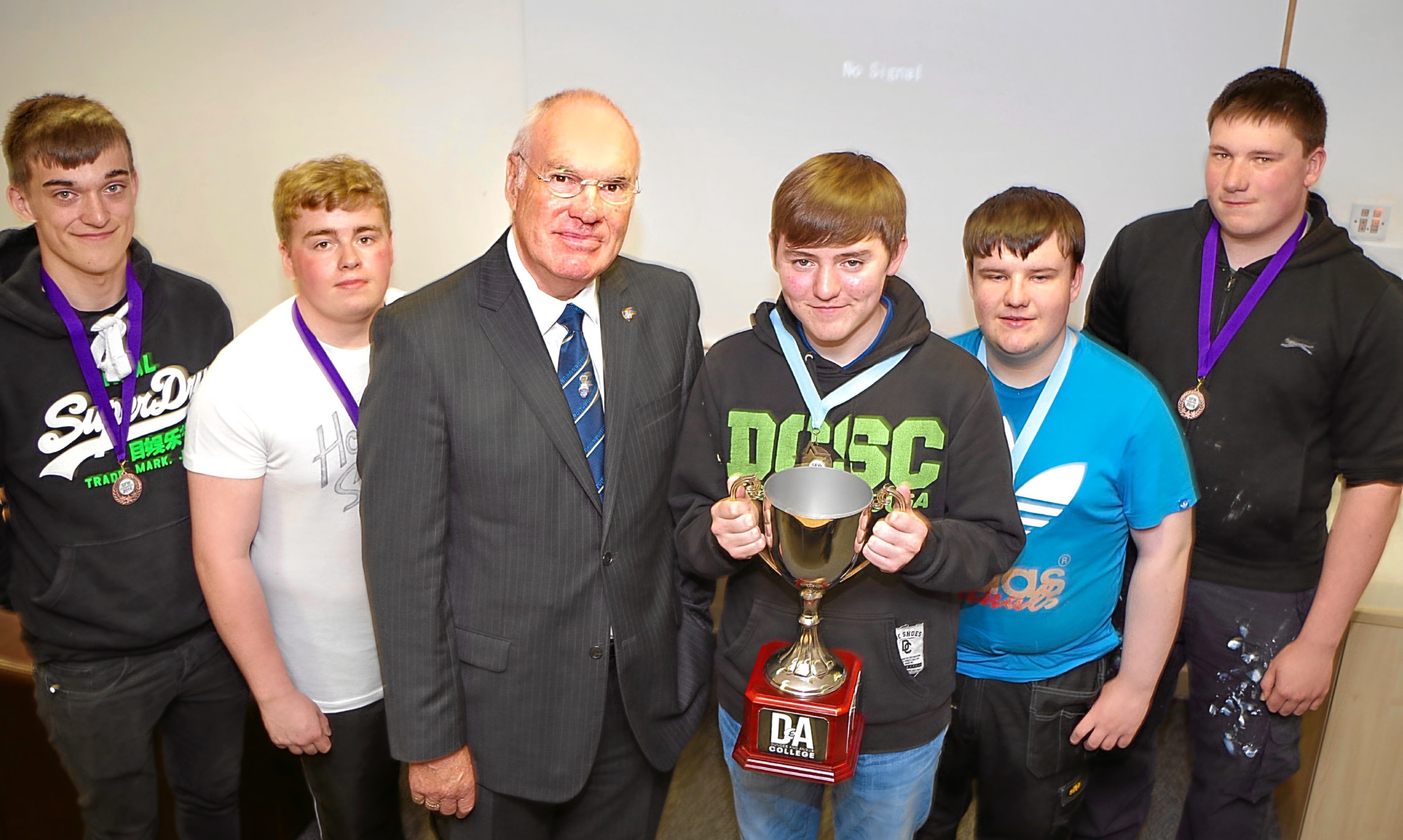 Deacon convenor of the Nine Trades of Dundee, Murray Petrie, presents John McCafferty with the trophy for winning a construction skills contest at D&A College, Arbroath Campus. Looking on are competition finalists, from left - Jenson Pye, Lee Robertson, Andrew Kinnear and Fraser MacIntosh.