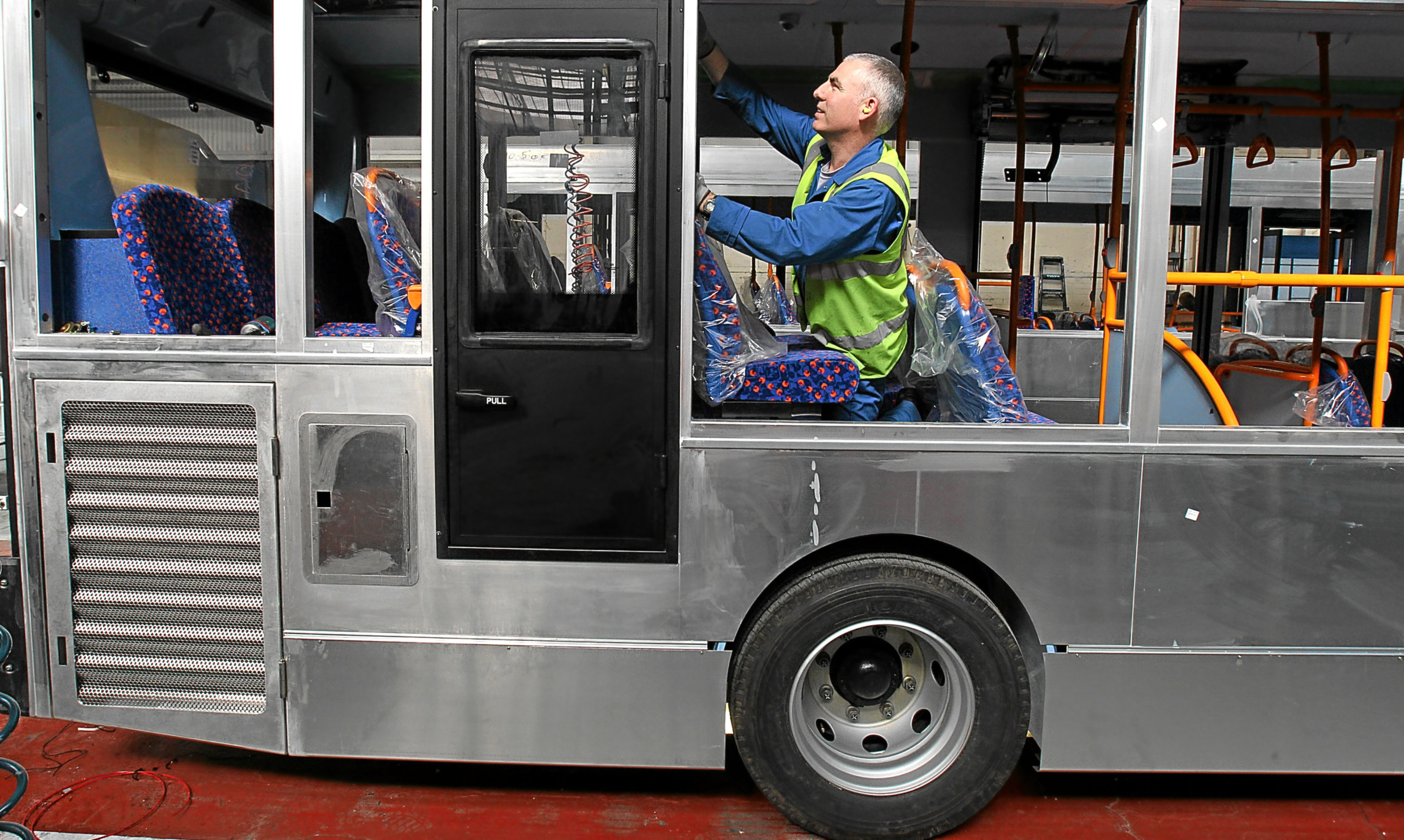 An Alexander Dennis technician at work