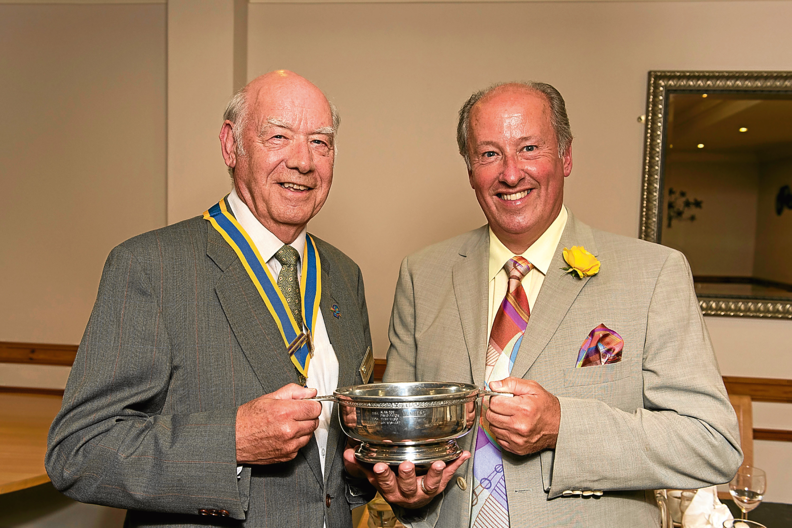 Joe Wishart (right) with outgoing Rotary President Tony Rance handing over the trophy.