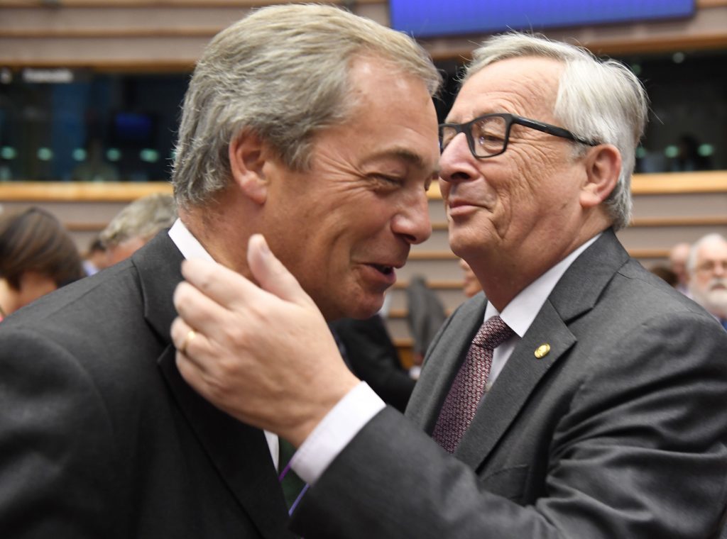 European Commission President Jean-Claude Juncker, right, greets UKIP leader Nigel Farage during a special session of European Parliament in Brussels on Tuesday, June 28, 2016. EU heads of state and government meet Tuesday and Wednesday in Brussels for the first time since Britain voted to leave the European Union, throwing British and European politics into disarray. (AP Photo/Geert Vanden Wijngaert)
