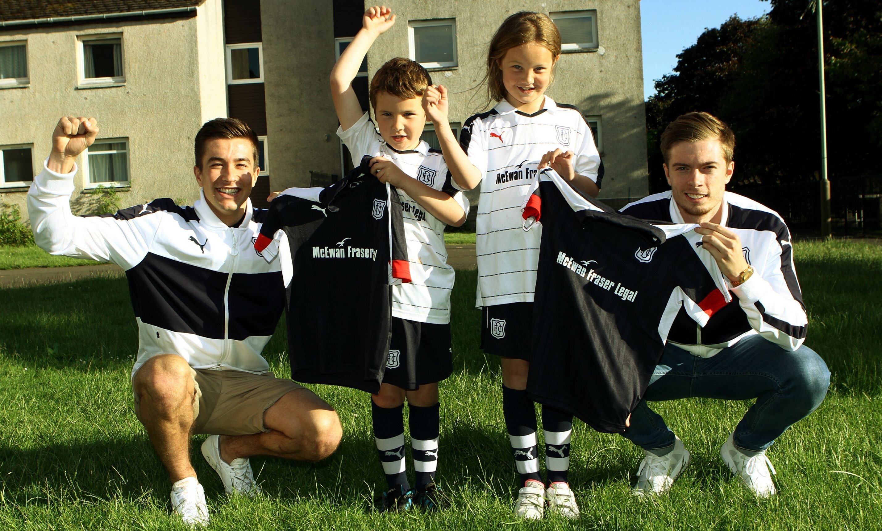 Dundee players Cammy Kerr and Craig Wighton presenting strips to Megan Riddell and brother Logan.