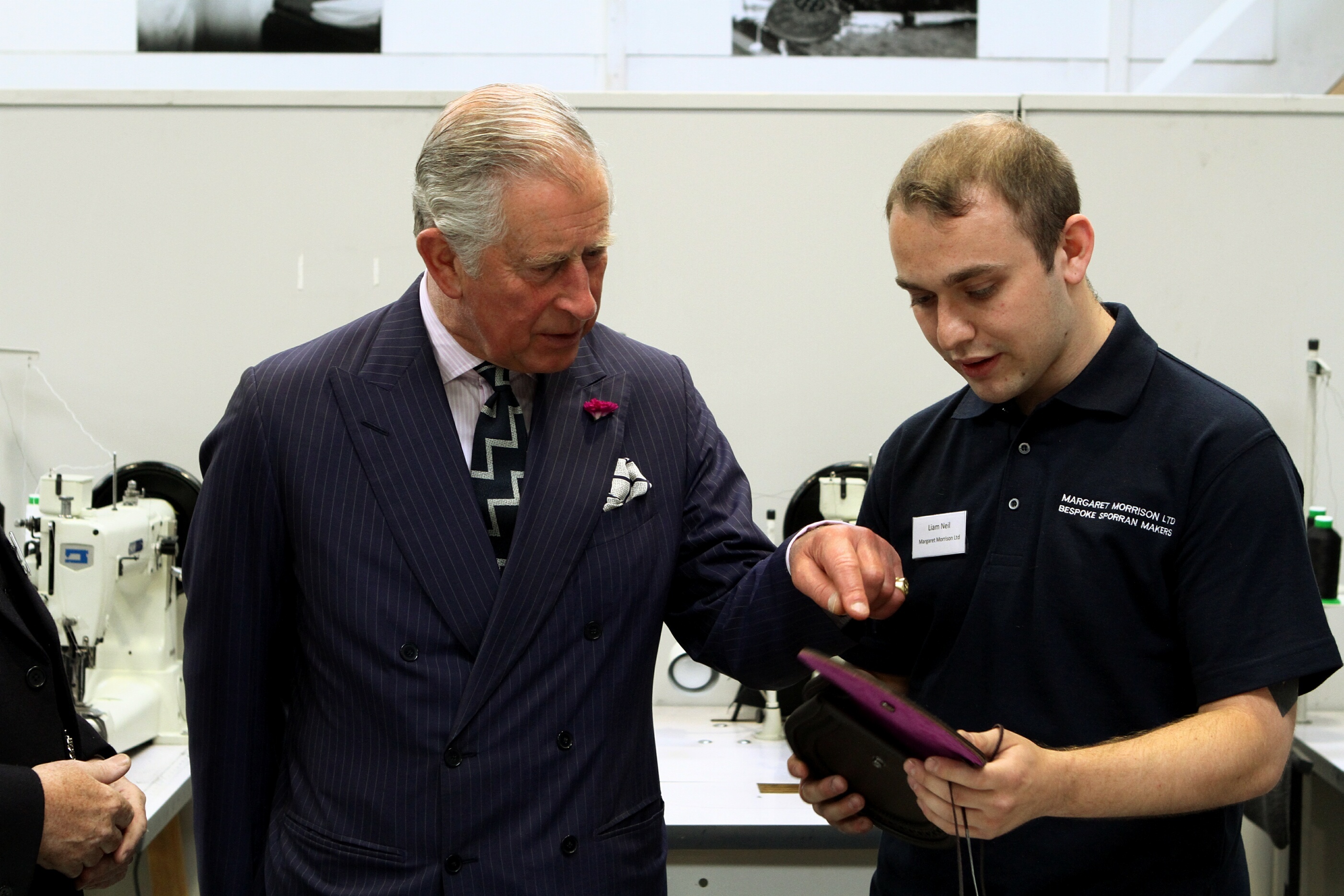 Liam Neil showing Prince Charles one of the sporrans in production.