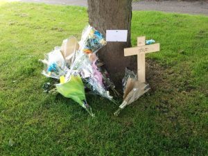Floral tributes at the spot where Darren Adie was found dying