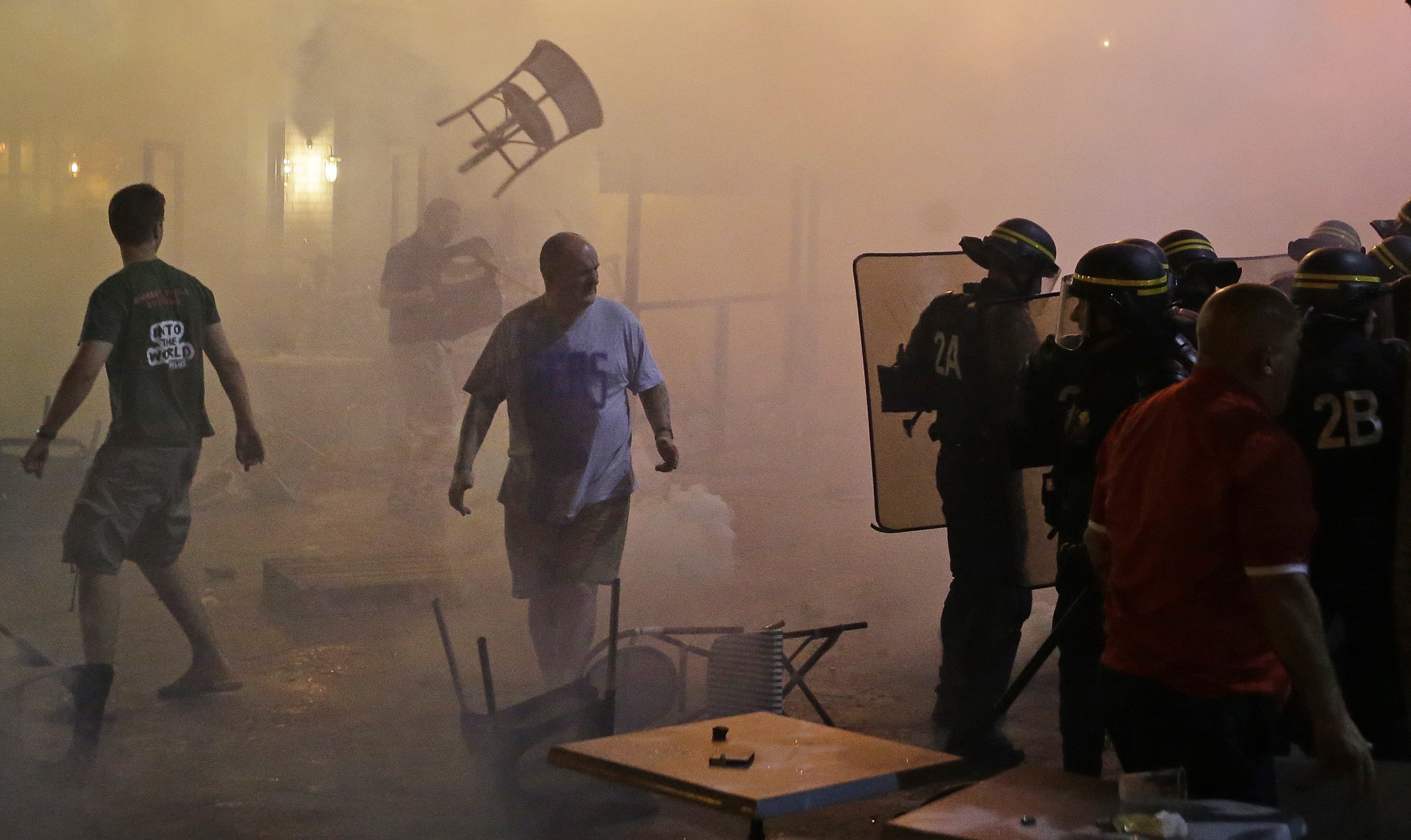 A chair flies through the air during clashes between police and England supporters in downtown Marseille.