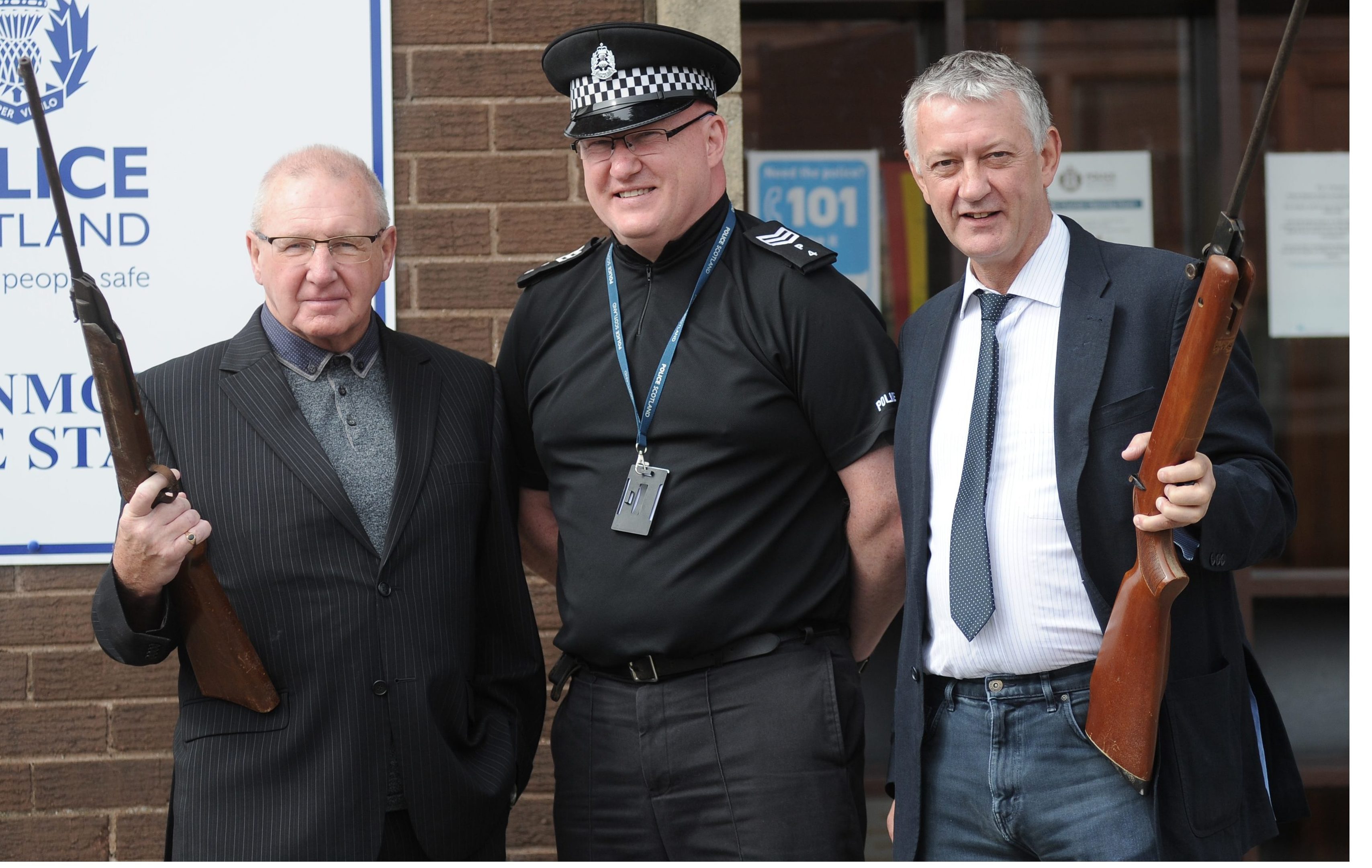 Councillor Bob Young (left) and Councillor Tom Adams handed in their unwanted air weapons to Sergeant Jim Anderson at Levenmouth police station.