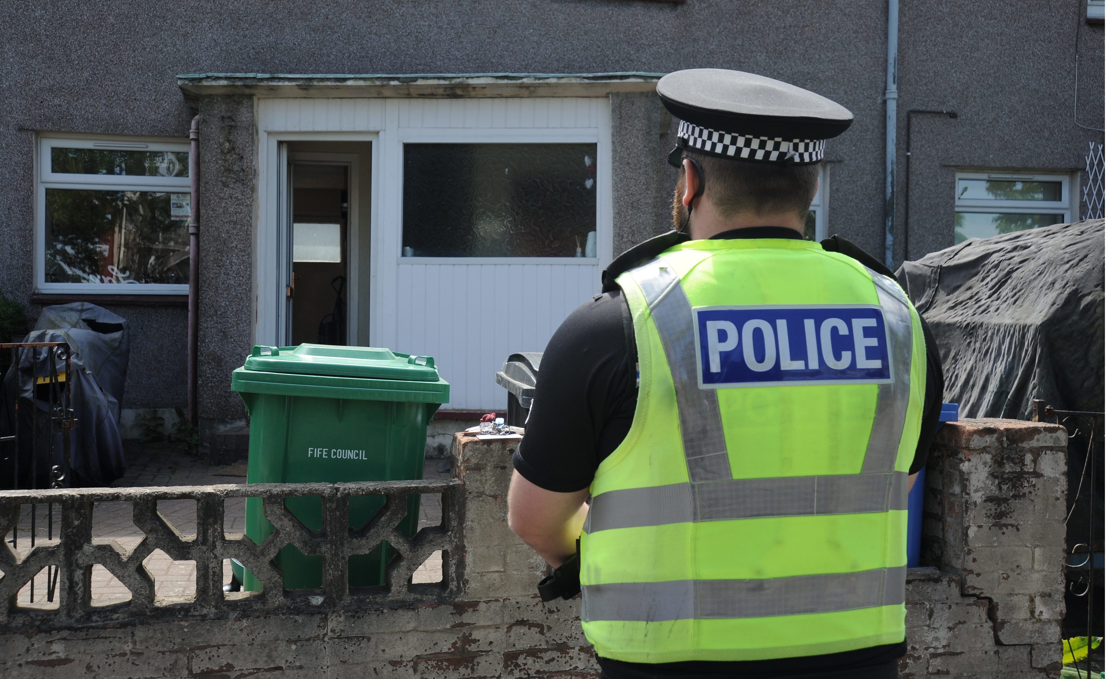 Police stand Guard outside a flat in Alexander Road after Wednesday's stabbing.
