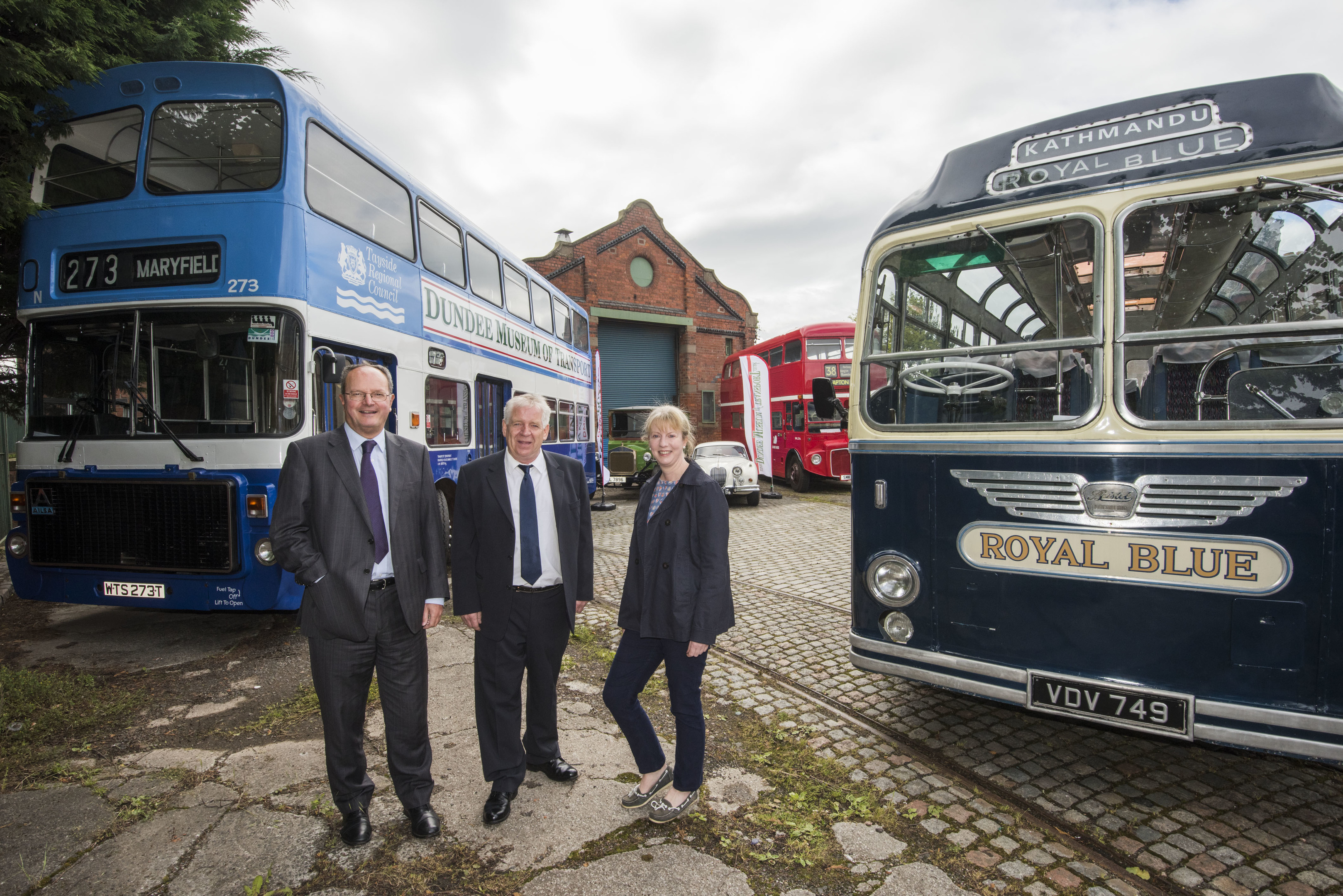 Jimmy McDonell, chairman of Dundee Museum of Transport, discussing the changes the funding will allow them to make with Martin Fairley, head of grants at HES, and MSP Shona Robison.