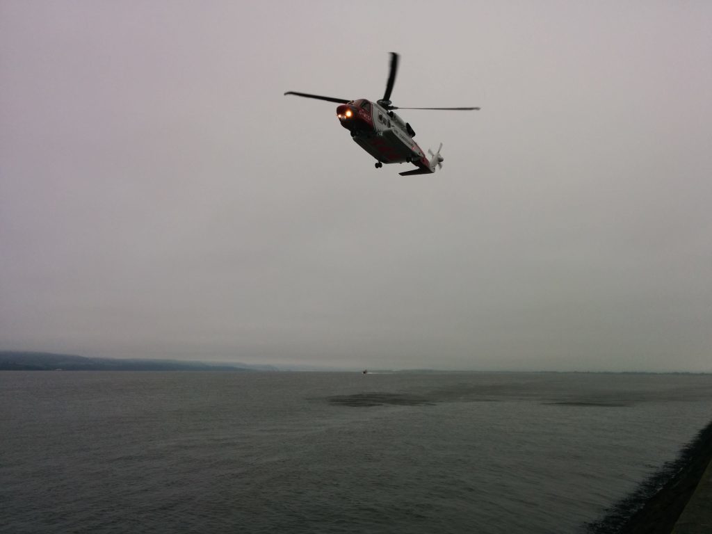 The Coastguard helicopter banks over the river Tay.