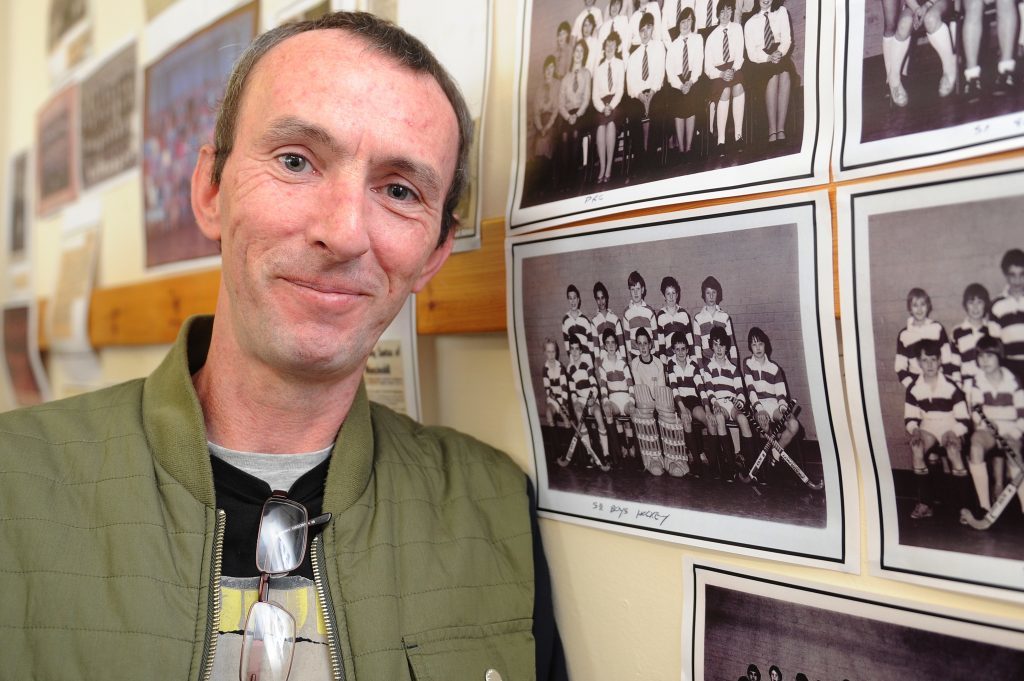 David McCabe with the picture of the S2 boy's hockey team that toured in Germany in 1982 that he was part of.